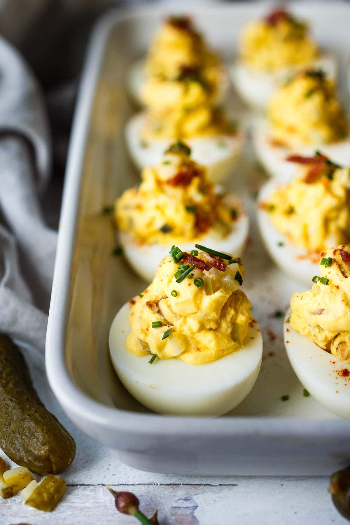 These deviled eggs have the best texture and flavor! Studded with crispy bacon (or vegan bacon), cheddar cheese, diced pickles, and sweet onions, they are creamy with delicious flavor.