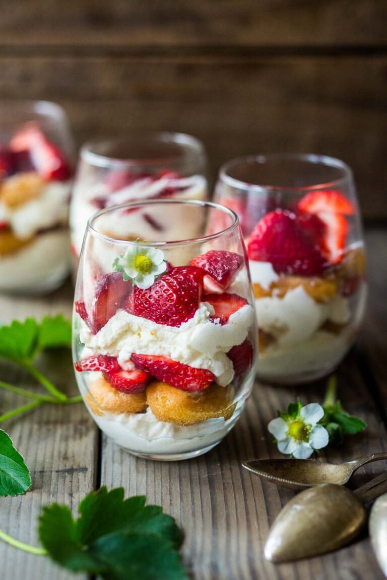 This strawberry tiramisu recipe is the perfect spring dessert. Fresh strawberries are layered with lady fingers soaked in orange juice and St. Germaine (elderflower liqueur) with a whipped mascarpone-yogurt cream. Light and refreshing, this one is a crowd pleaser.