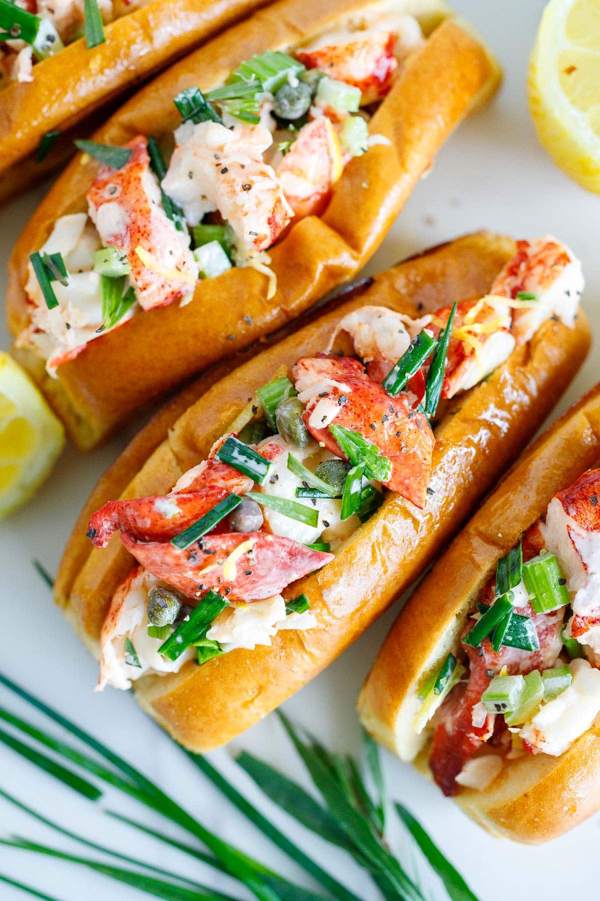 Maine-style lobster rolls with lobster mayo filling in split-top buns.