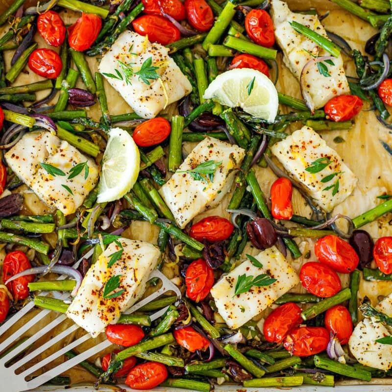 This Mediterranean baked cod recipe couldn't be any easier! Packed with veggies, olives, lemon, and herbs, this easy and healthy weeknight dinner is ready in just 30 minutes.