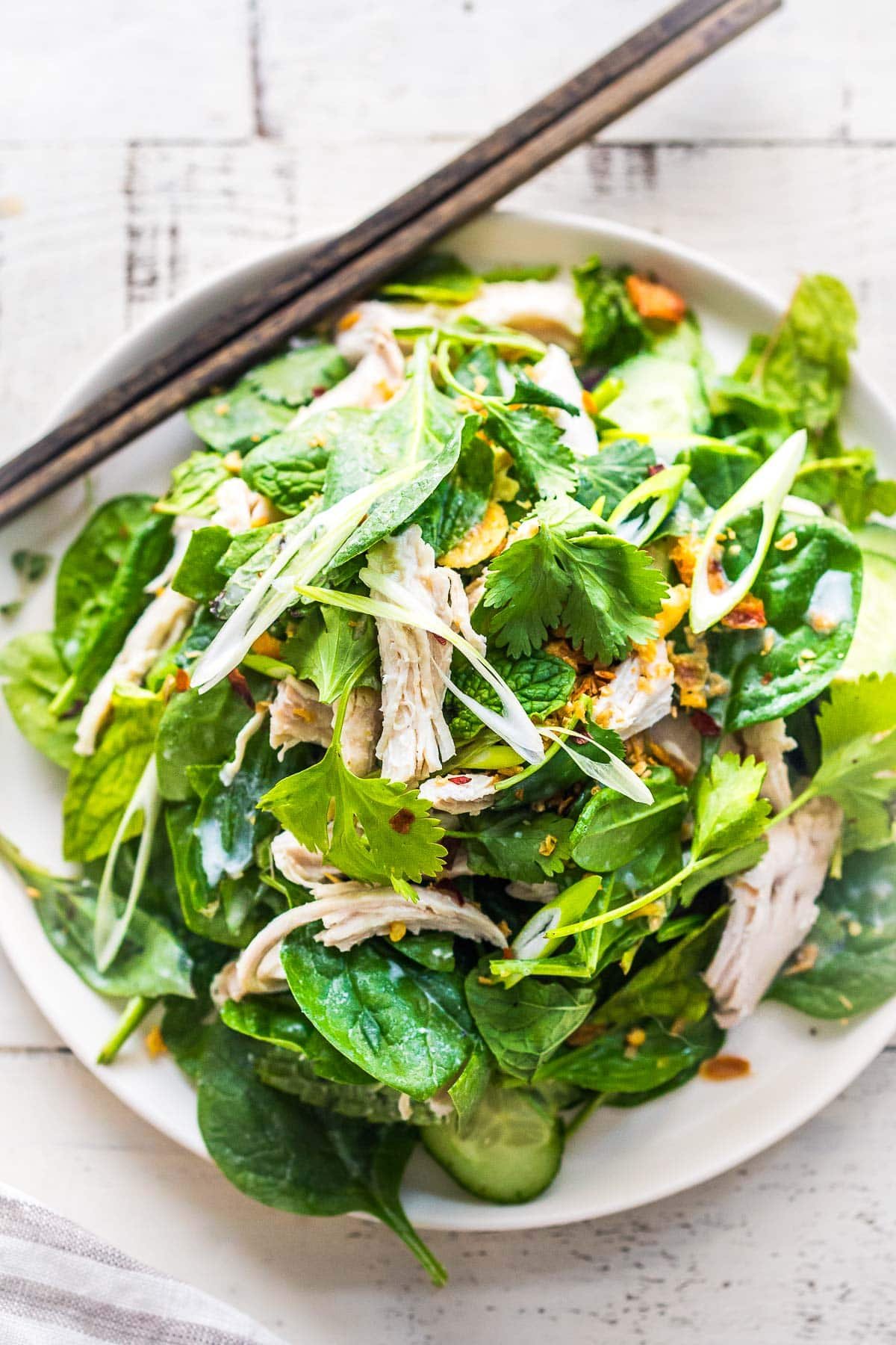 Coconut poached thai chicken salad with spinach, herbs and crunch.