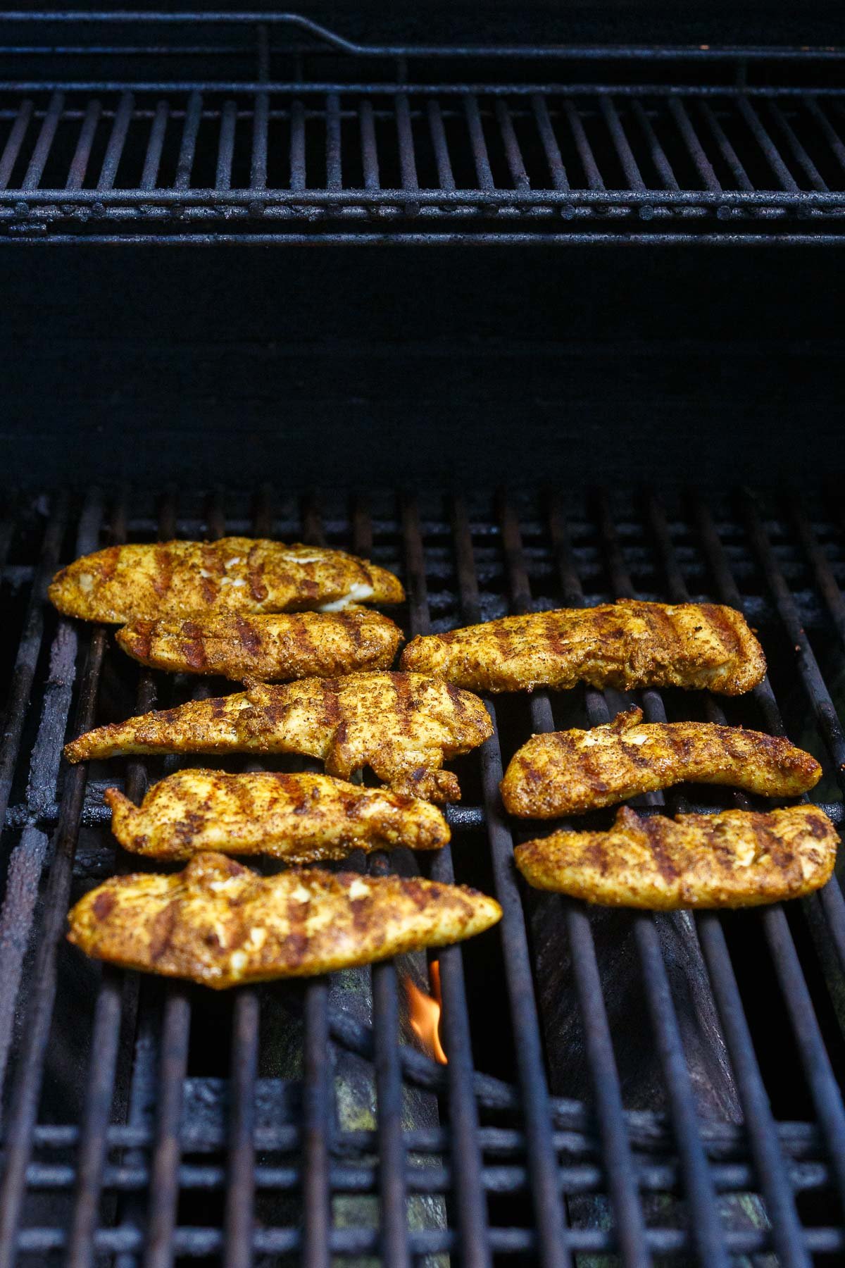 chicken shawarma with grill marks on grill. 