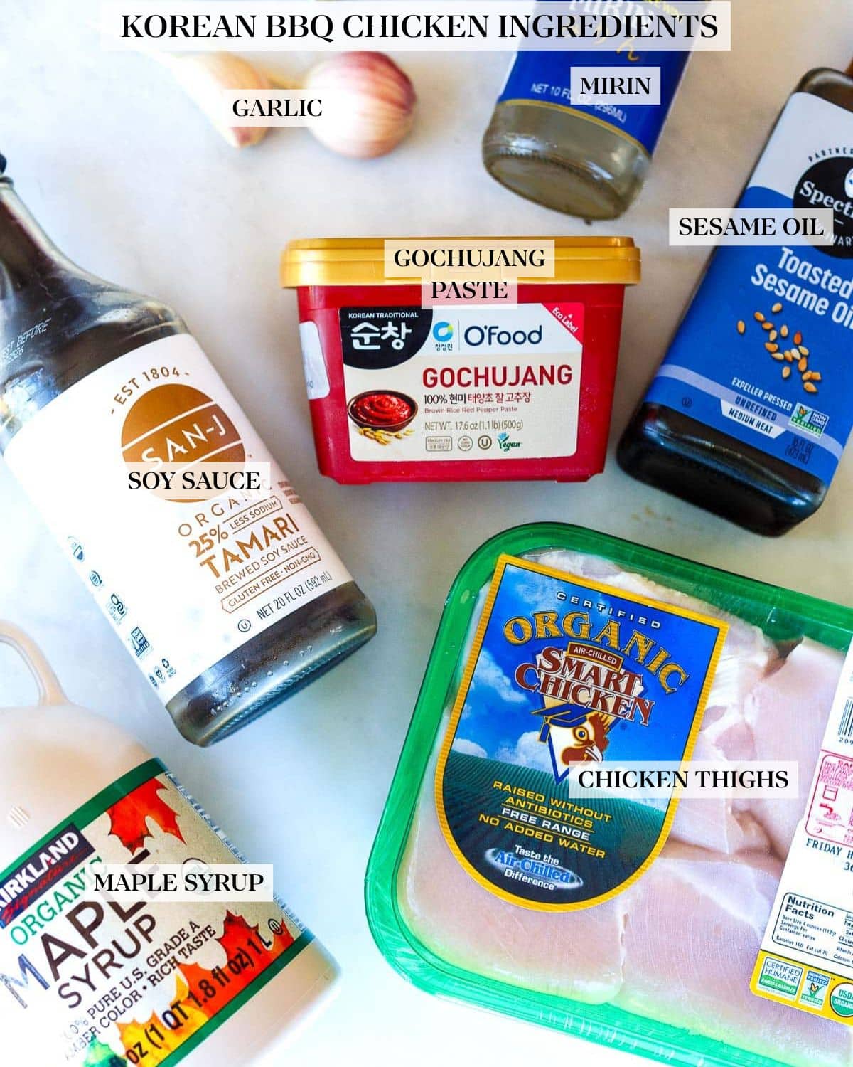 ingredients laid out for korean bbq tofu- garlic, mirin, toasted sesame oil, gochujang, tamari, organic chicken, maple syrup.