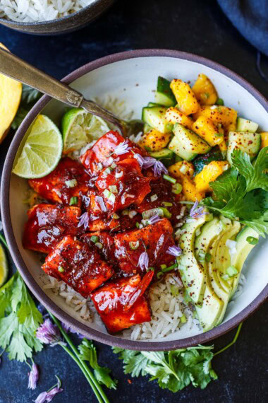 Spicy sticky gochujang-glazed salmon meets cool mango-cucumber salsa in this bold, Korean-inspired rice bowl. Served with jasmine rice and creamy avocado, it’s a healthy, flavor-packed meal perfect for weeknights.