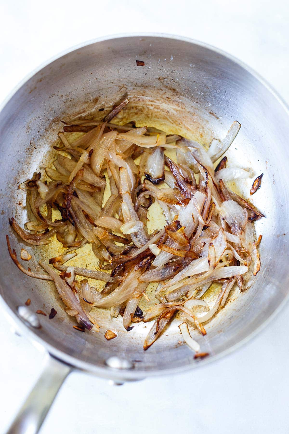 Shallots sautéing in a pan.