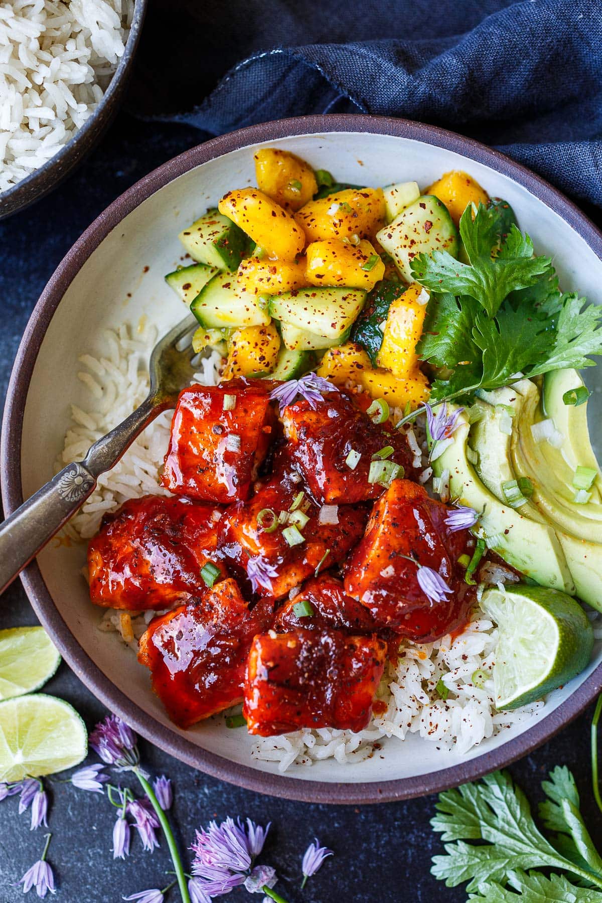 Sticky gochujang salmon, fresh mango-cucumber salsa, jasmine rice, and avocado come together in this bold, healthy Korean-inspired bowl.