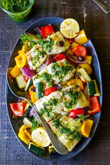 This Mediterranean baked cod recipe couldn't be any easier! Packed with veggies, olives, lemon, and herbs, this easy and healthy weeknight dinner is ready in just 35 minutes.
