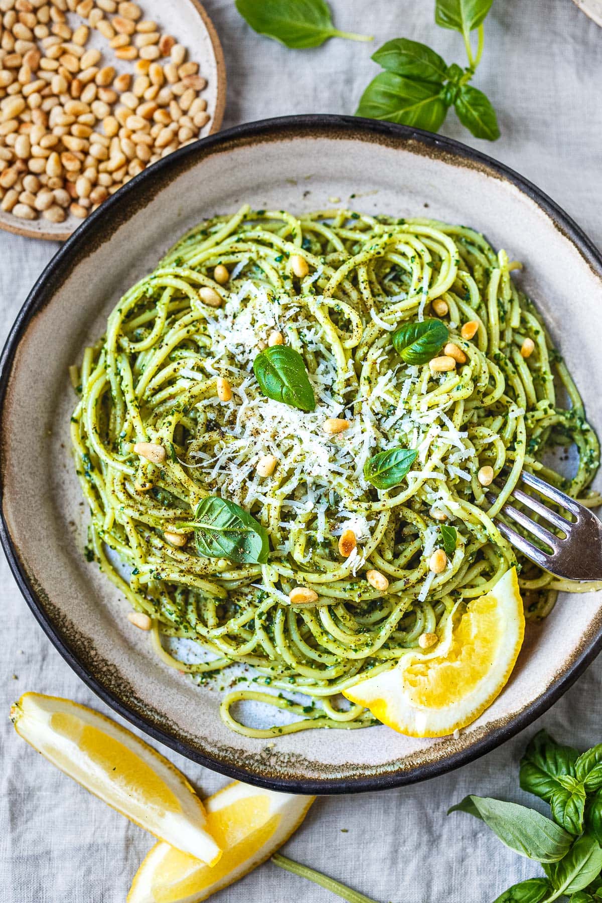 pesto pasta recipe with pine nuts in a bowl.