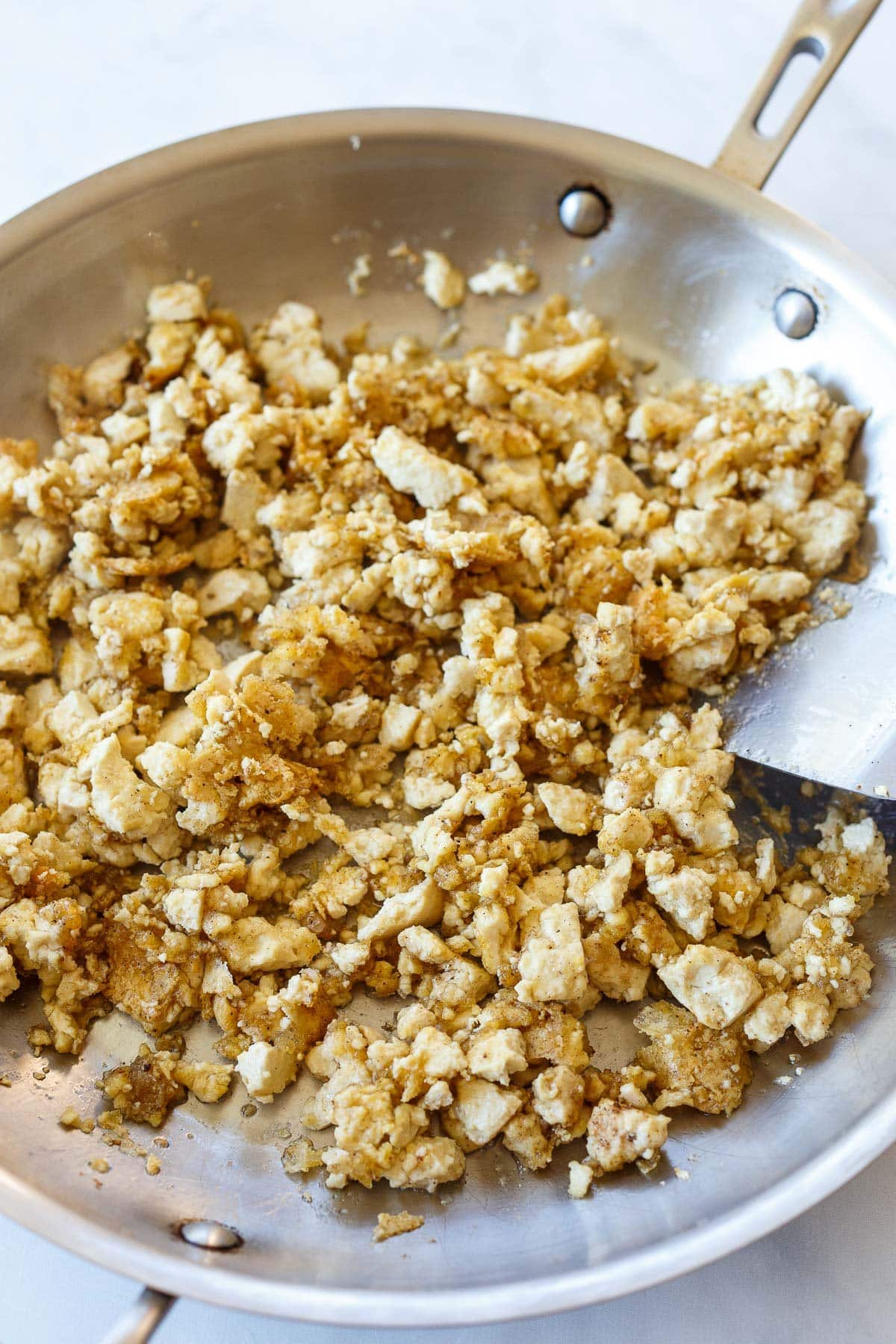 Tofu cooking in a pan.