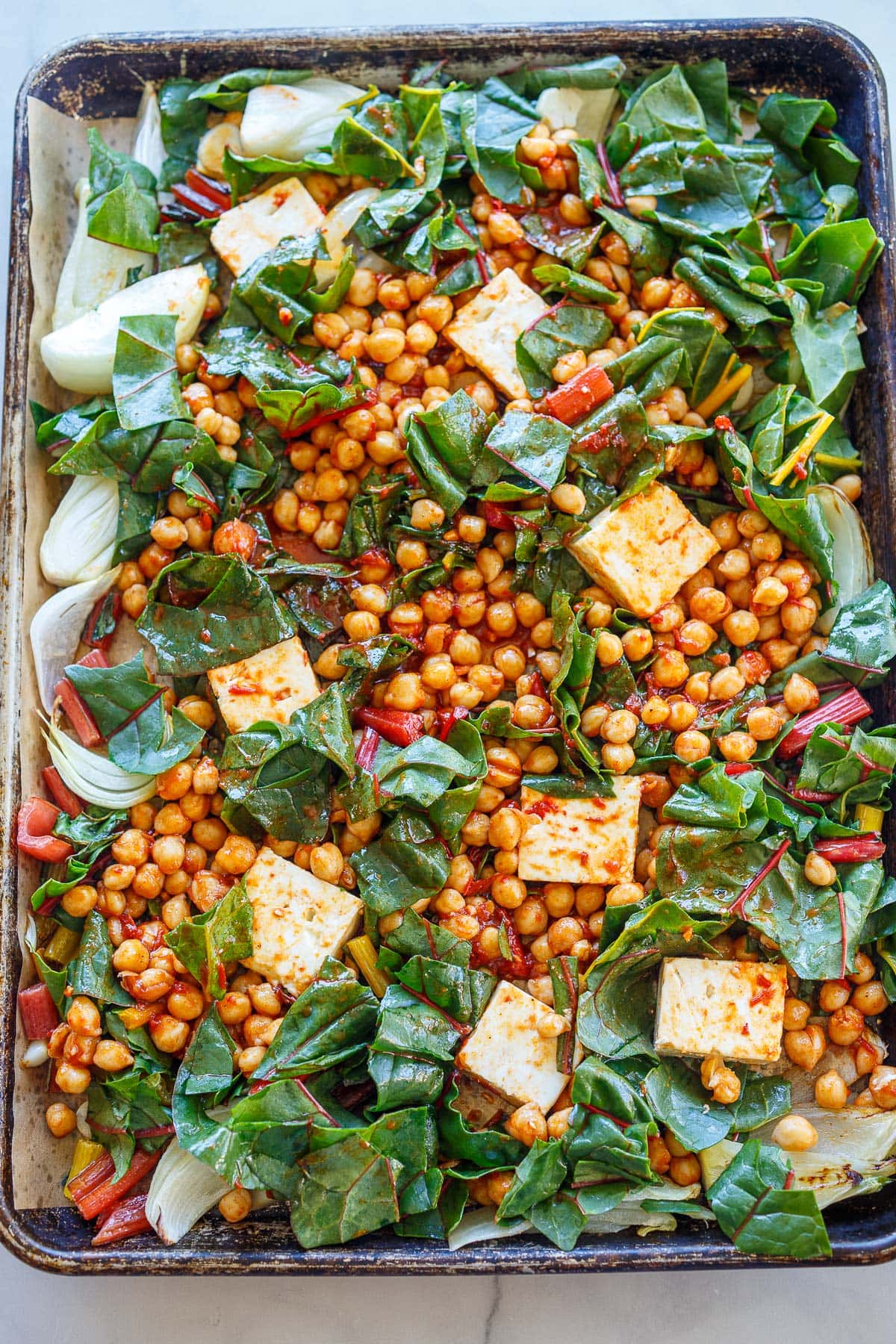 sheet pan with feta squares, chickpeas, and chard.