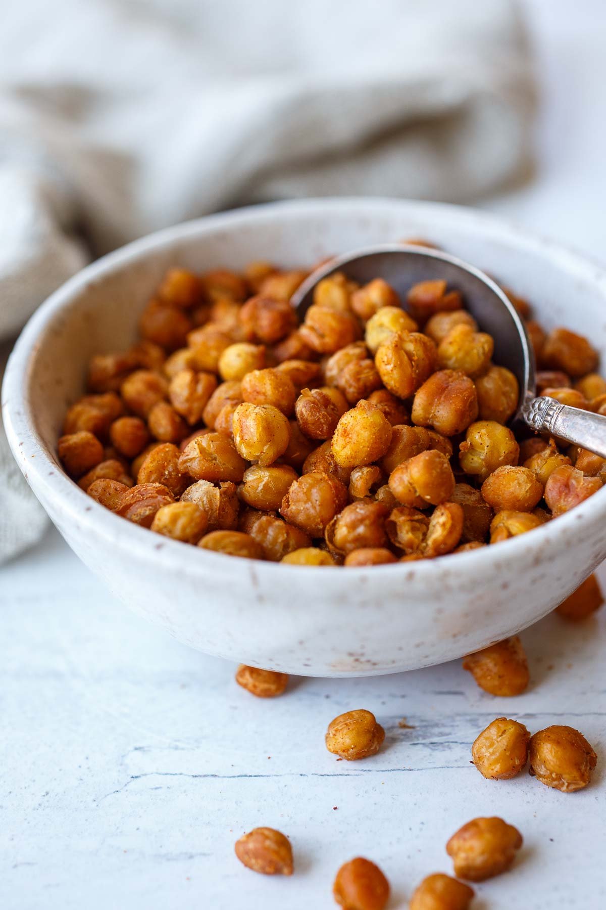 small bowl of roasted chickpeas with spoon. 