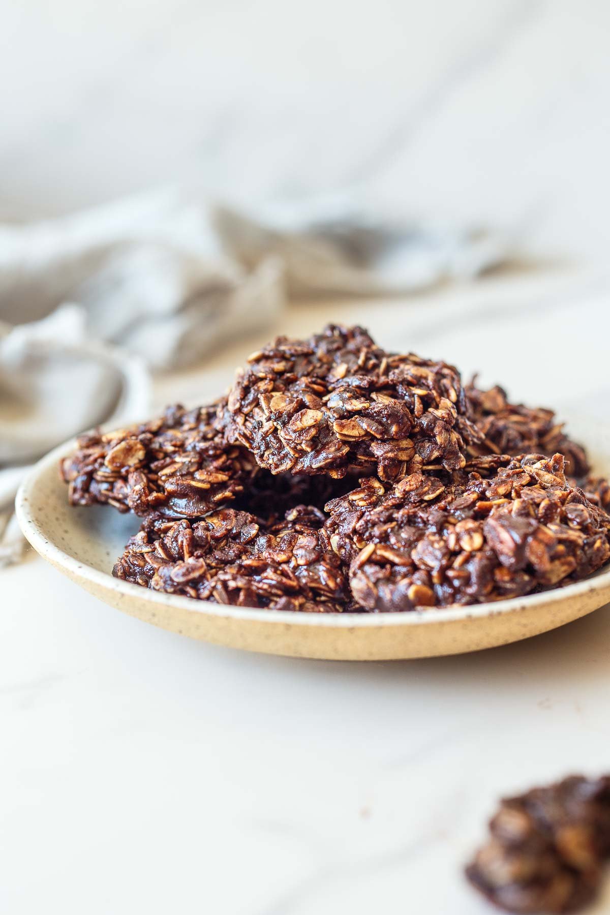 plate with a pile of chocolate no bake cookies.