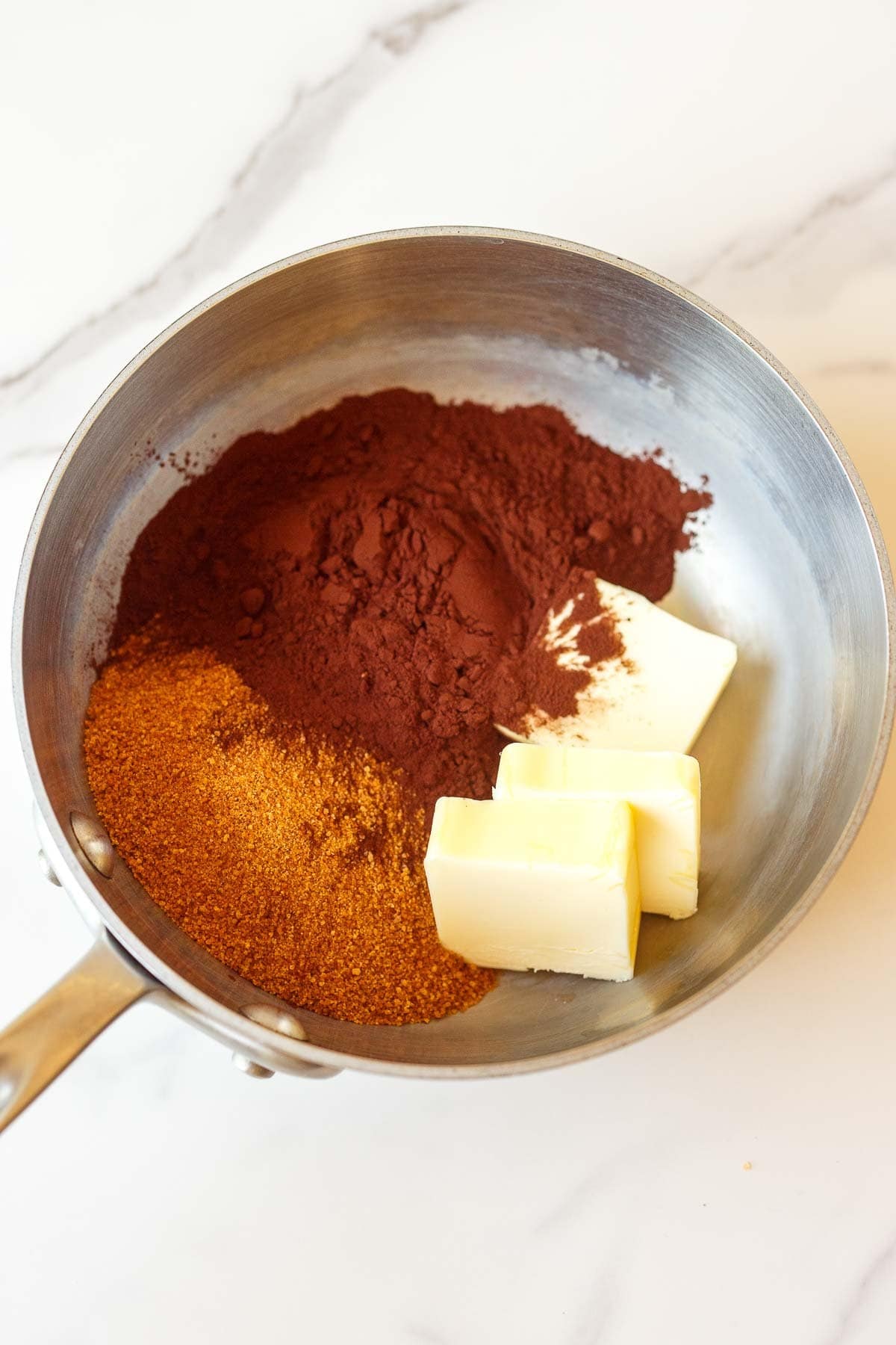 saucepan with sugar, cocoa powder, and butter. 
