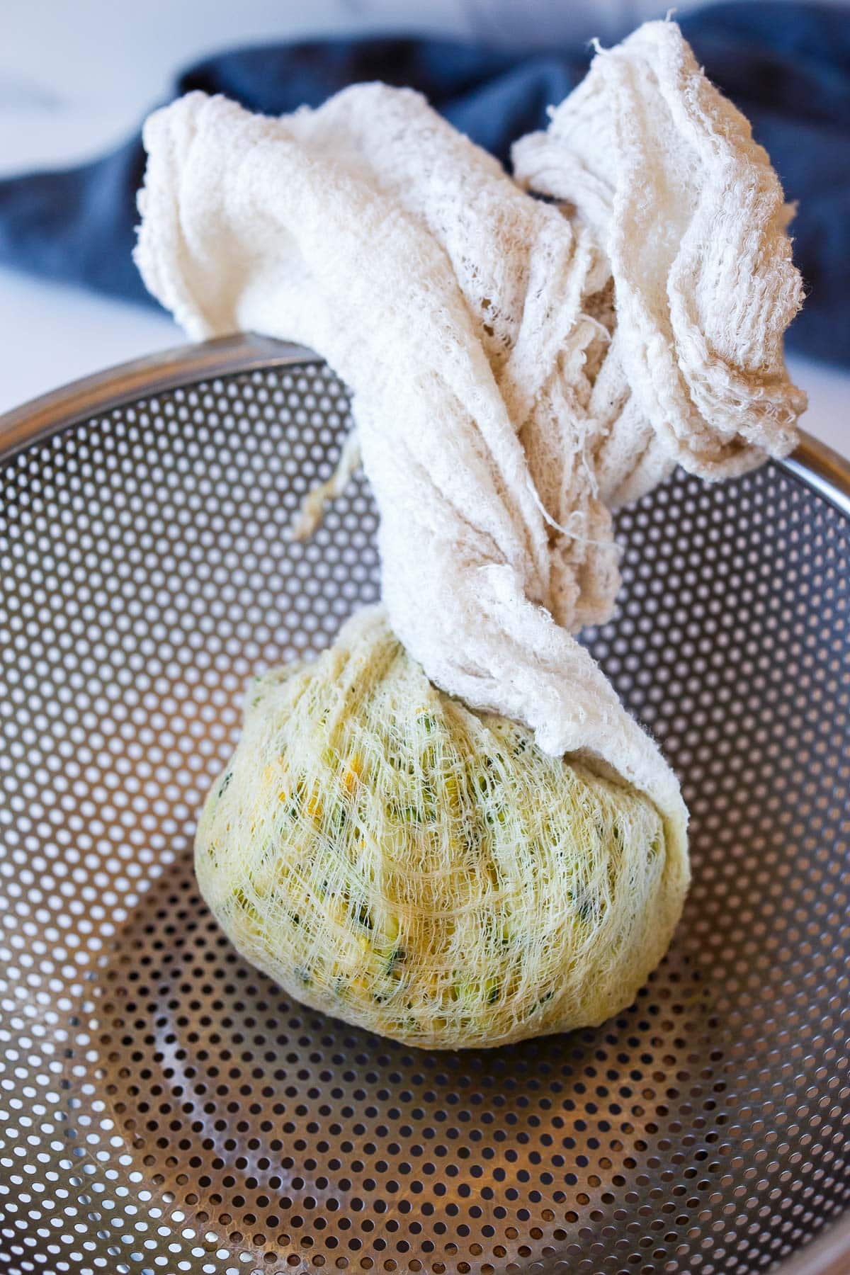 grated zucchini in cheesecloth, twisted to removed excess moisture.