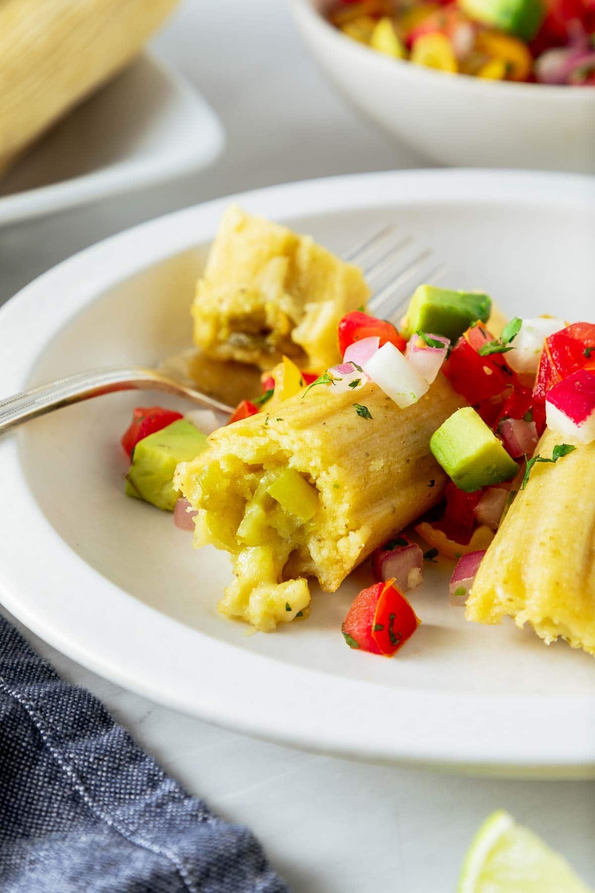 a fork cutting into a homemade tamale.