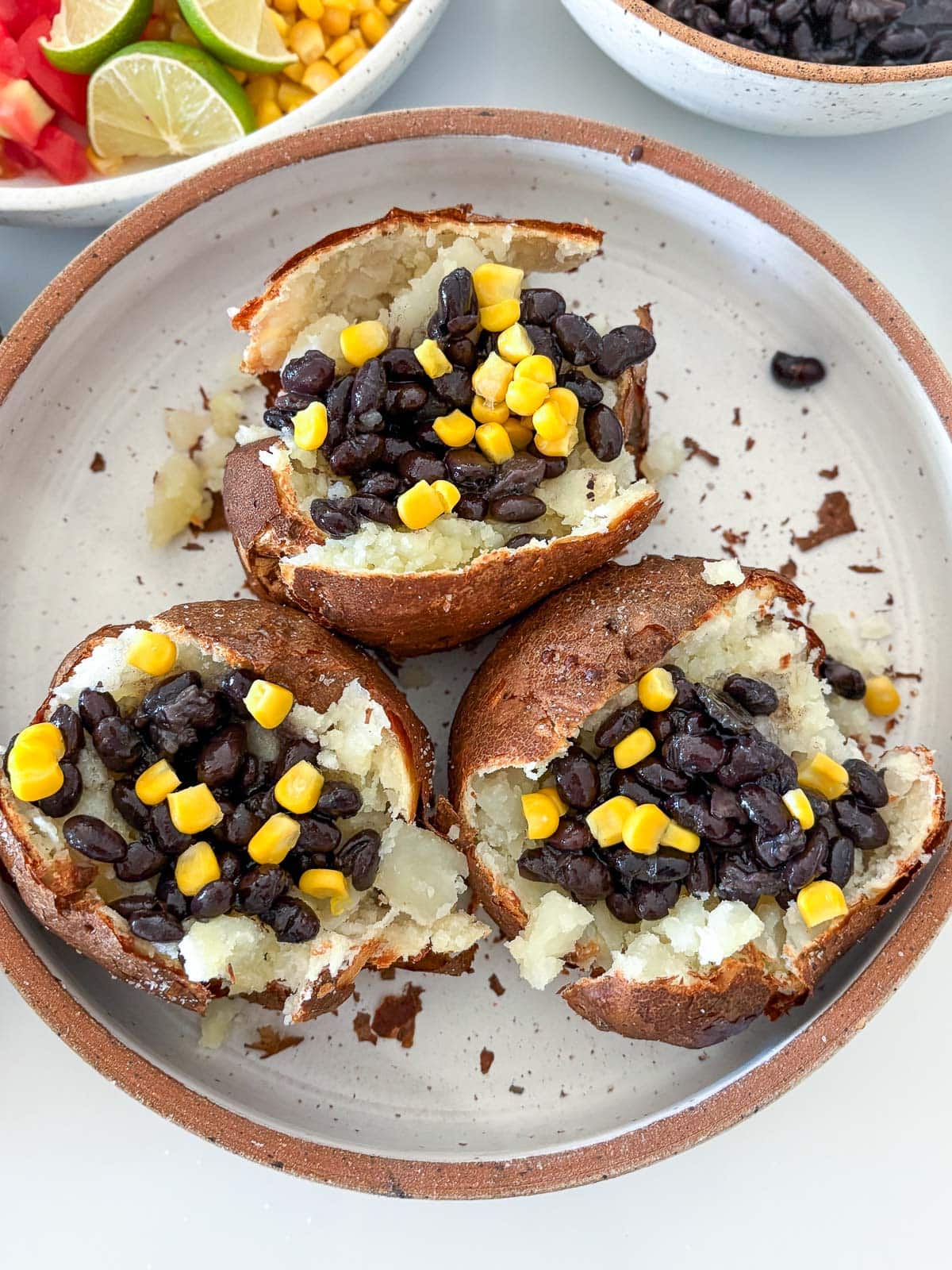Stuffing the baked poatoes with black beans and corn.