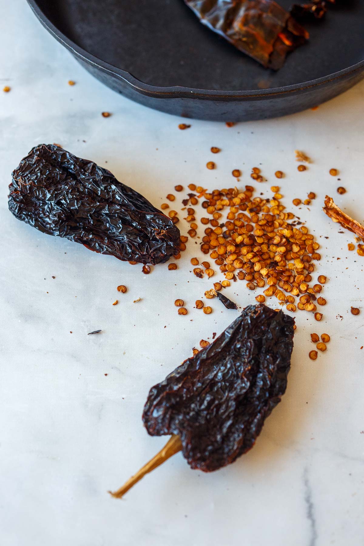 two dried chilis with seeds removed. 