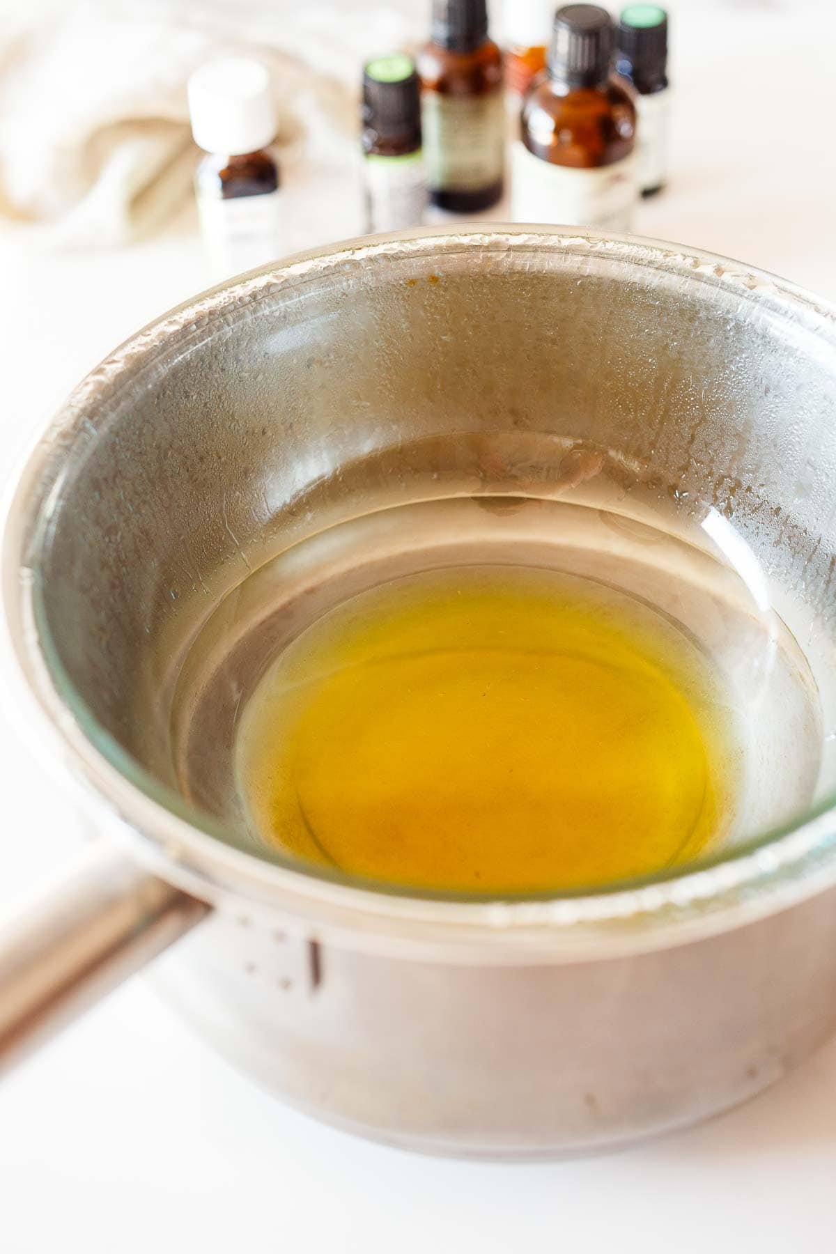 pot with glass bowl of jojoba oil and other ingredients placed in the pot. 