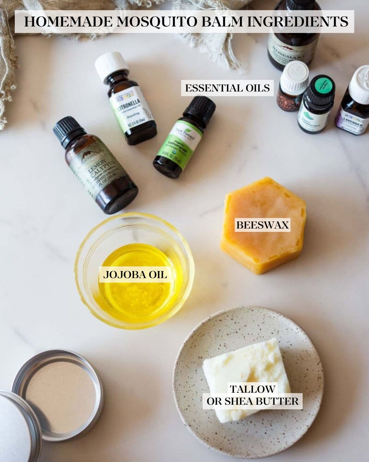 homemade mosquito balm ingredients laid out on counter and labeled - essential oils, beeswax, jojoba oil, and tallow or shea butter. 