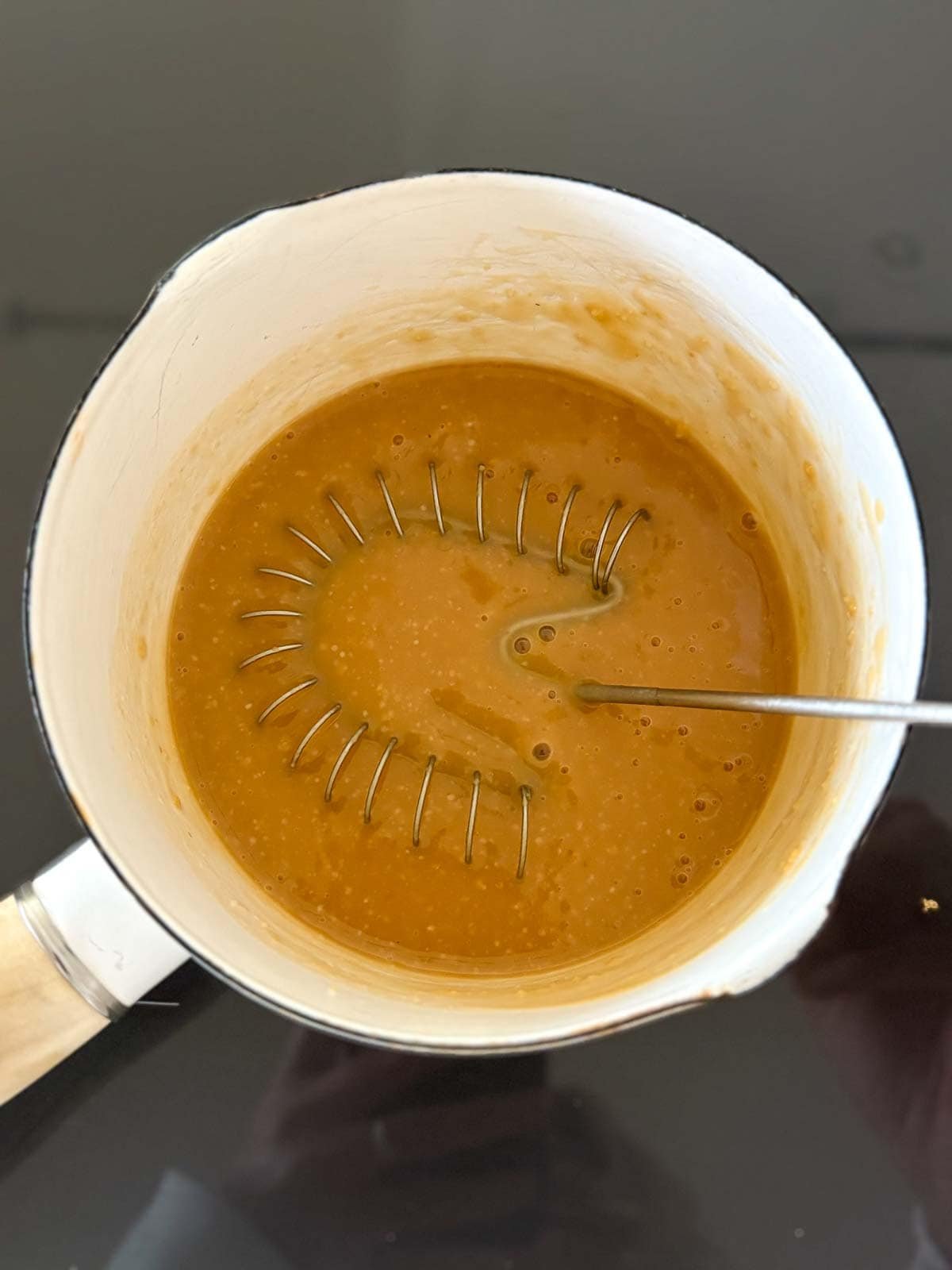 whisking the marinade on the stove. 