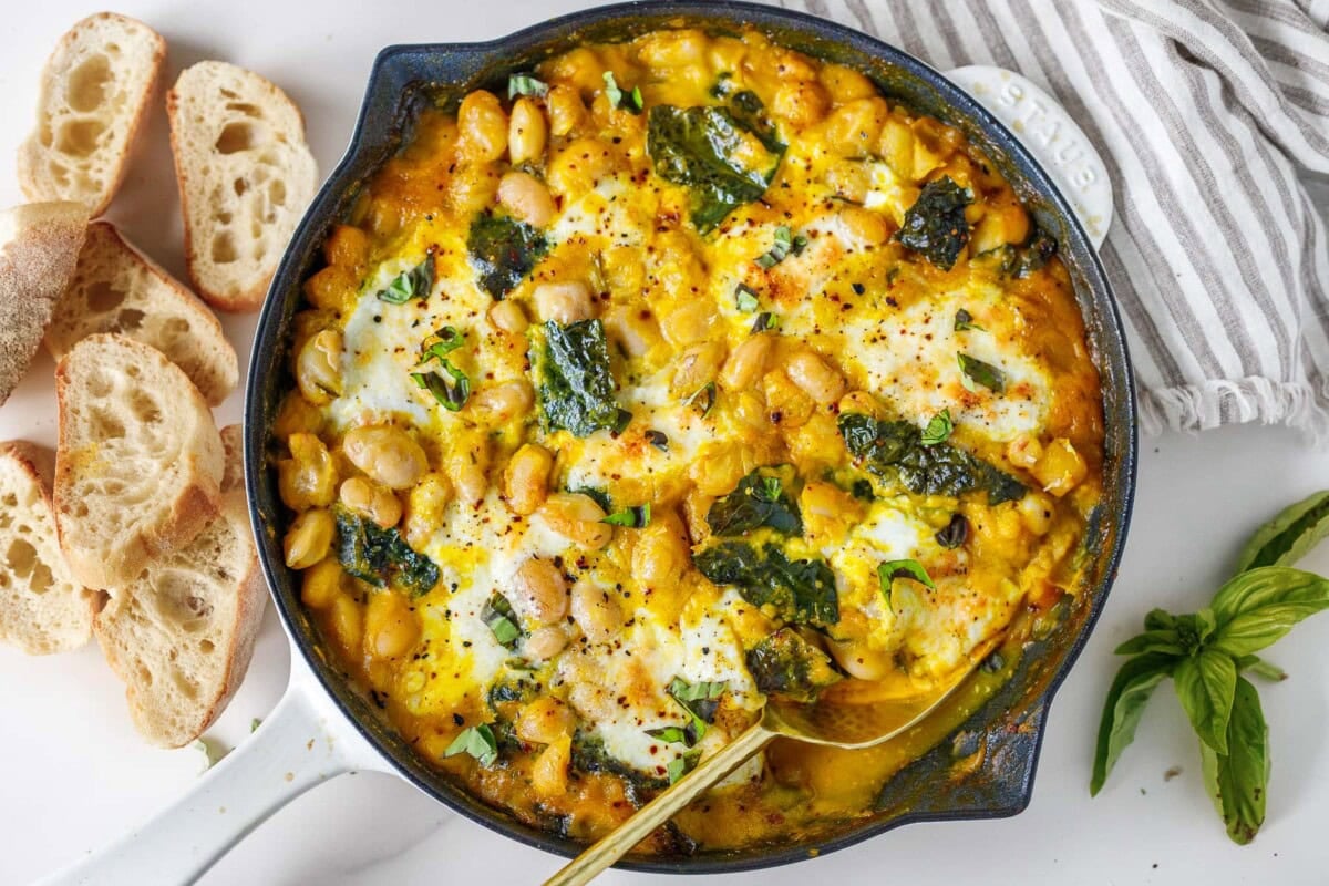 This fall-inspired recipe for baked beans with creamy butternut sauce, kale, basil, and burrata cheese is so cozy! A delicious vegetarian meal perfect for fall!