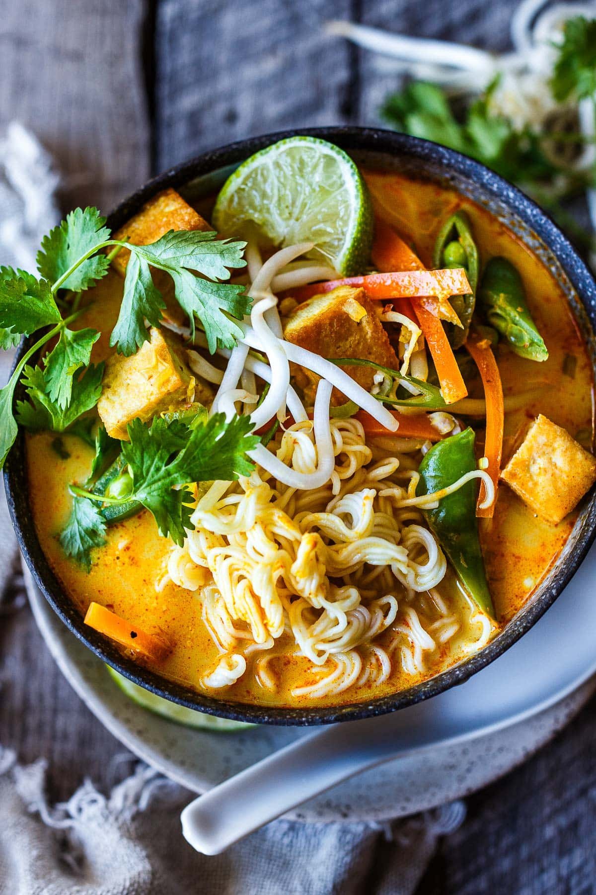 This Curry Ramen recipe features a creamy coconut broth with a kick of warm curry spice, complementing crunchy veggies, tender tofu, and succulent ramen noodles. Vegan.