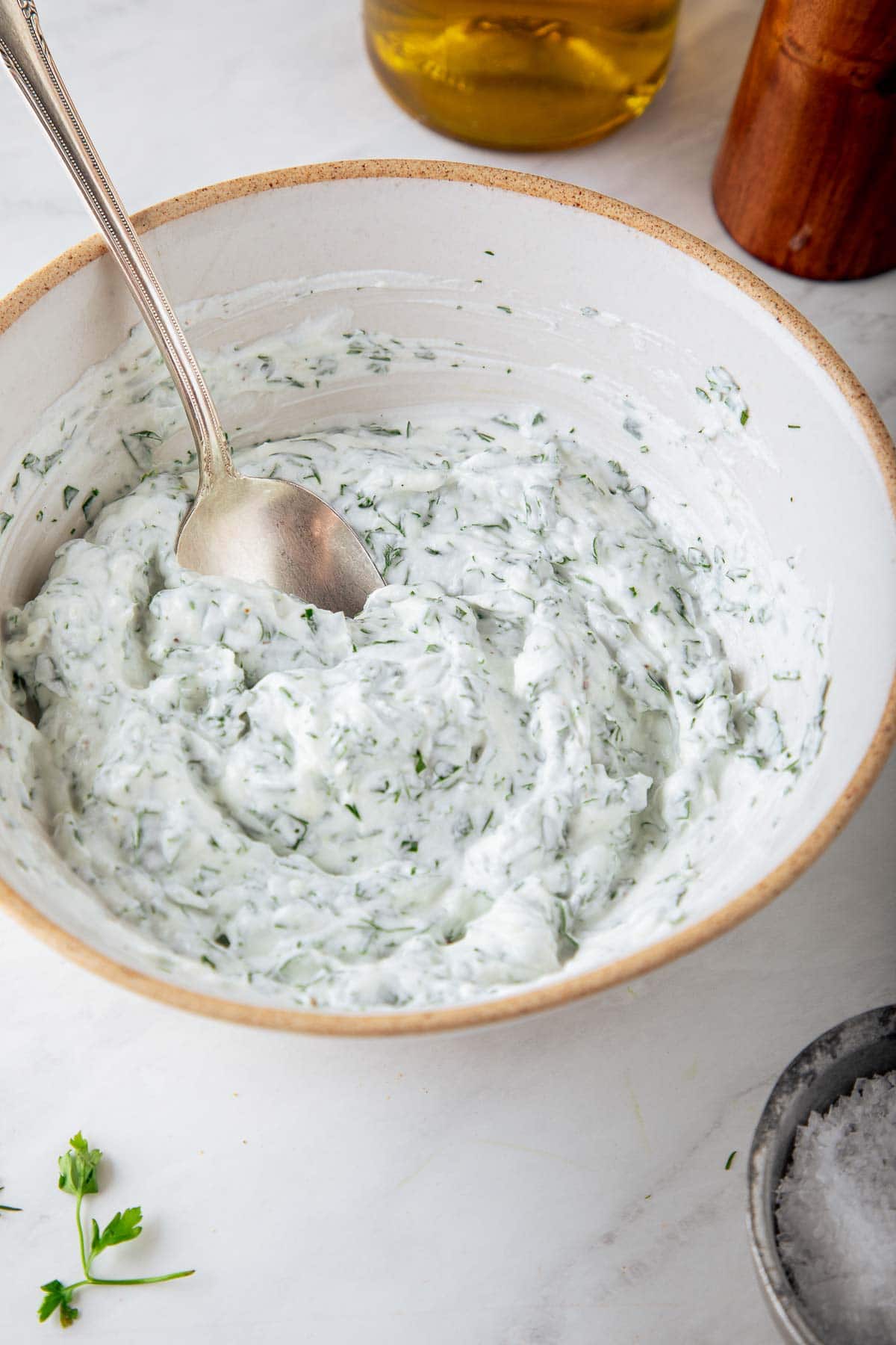 bowl of herbed yogurt with spoon. 