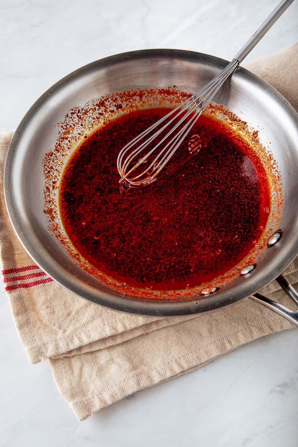 small whisk and skillet with Aleppo butter. 