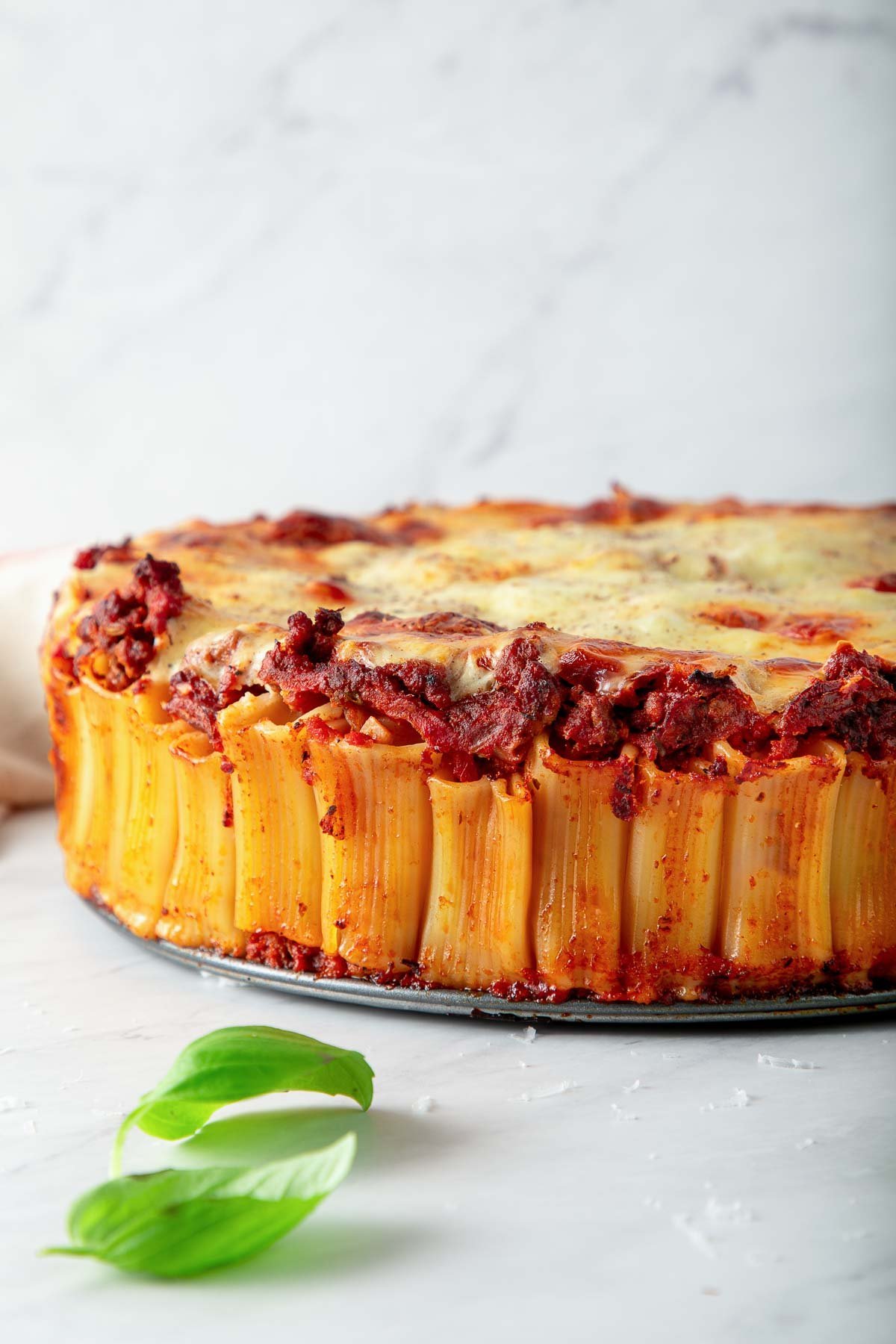 baked rigatoni in the honeycomb pattern with upright rigatoni topped with tomato meat sauce and golden béchamel sauce.