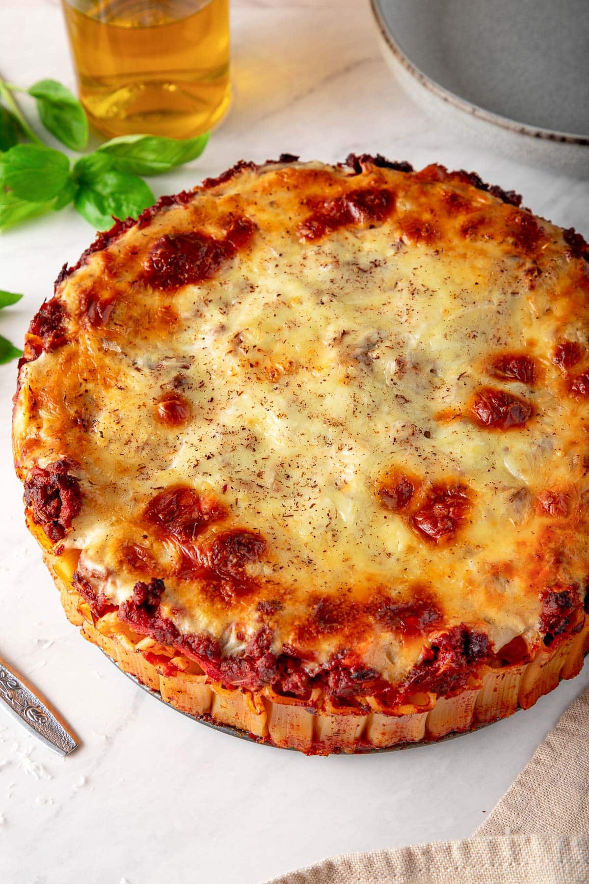 baked rigatoni in honeycomb pattern with golden, browned béchamel layer on top.