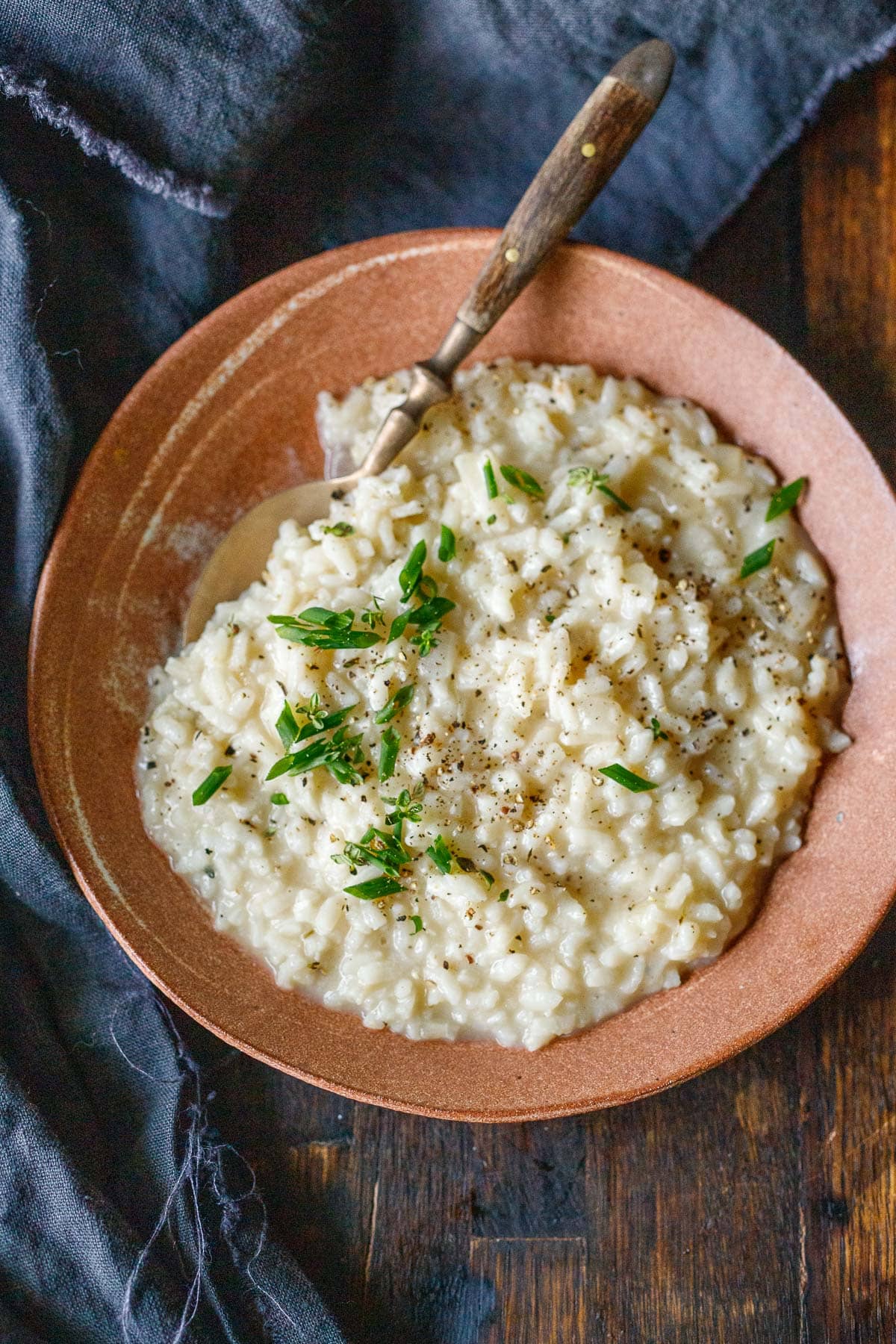 Creamy Instant pot risotto in a clay bowl.