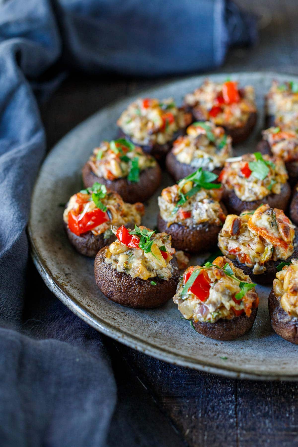 stuffed mushrooms on plate garnished with parsley.