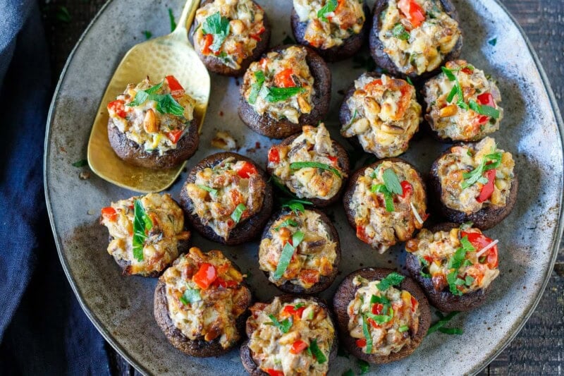 These stuffed mushrooms are elegant, crowd-pleasing, and easy to make-a catering favorite made with pine nuts, fresh herbs, lemon zest, and cream cheese. Gluten-free and vegan-adaptable!