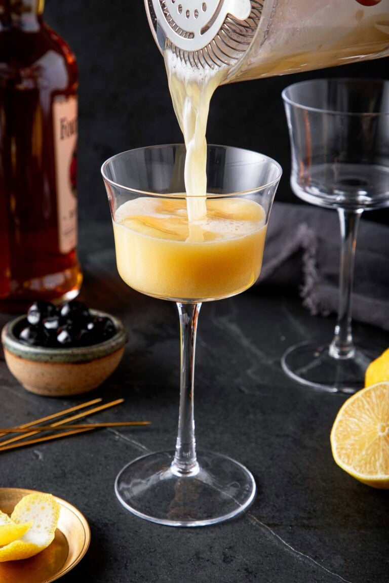 Celebrate the holidays with a classic Whiskey Sour made with bourbon, fresh lemon, honey syrup, and egg white—simple, silky, and perfectly festive.