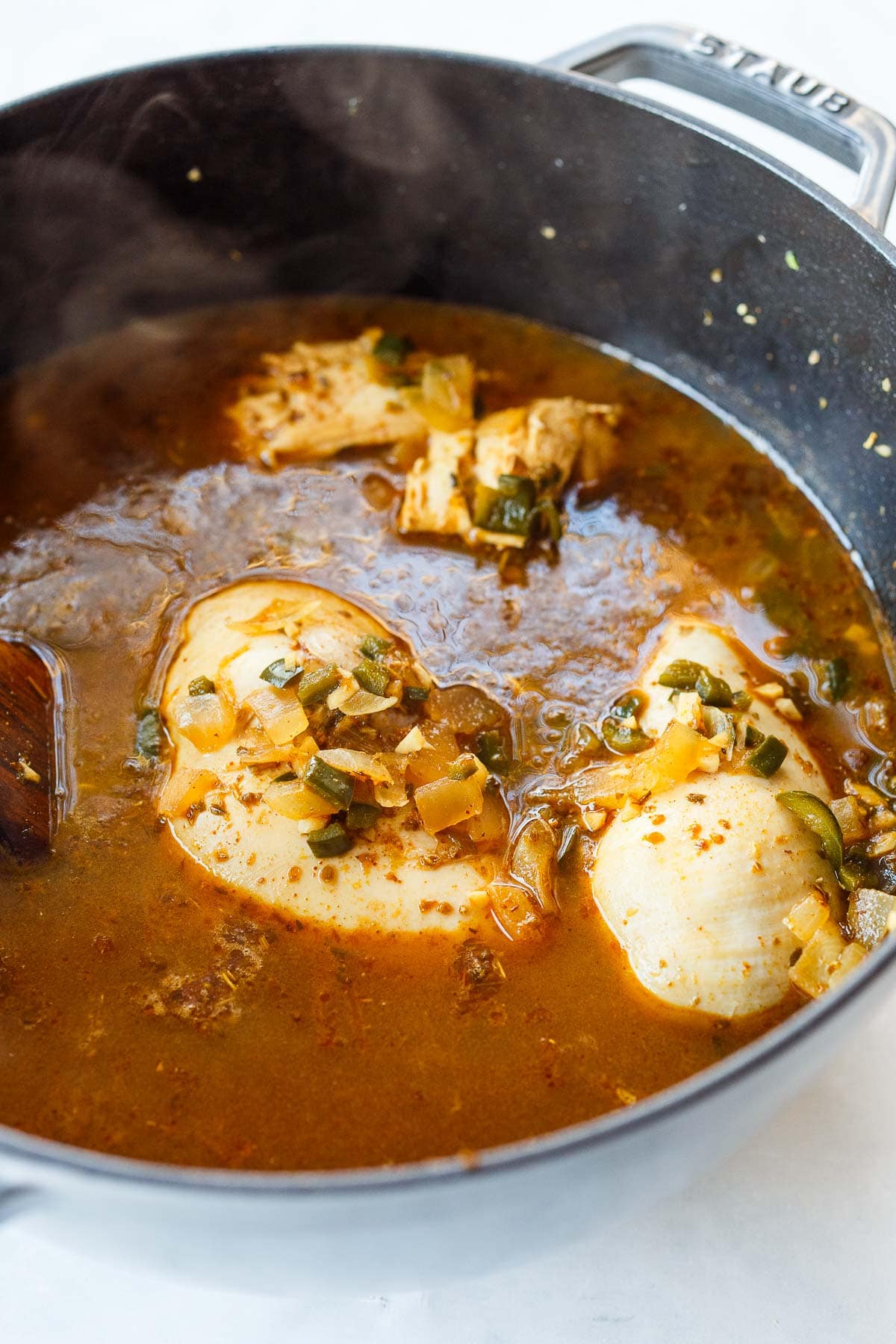Adding the chicken and bringing to a simmer. 