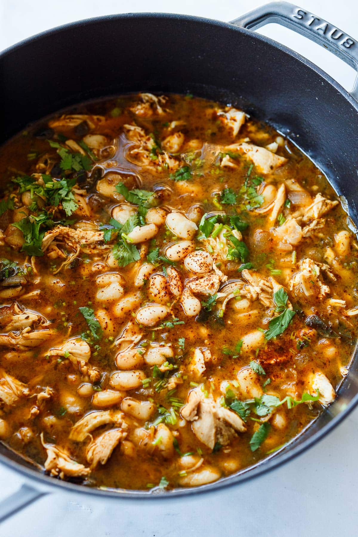 Adding the white beans and seasoning to taste. 