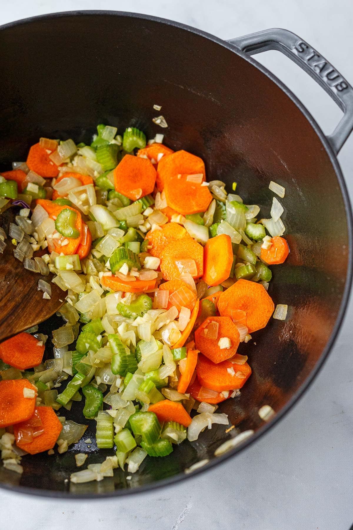 dutch oven with sautéed carrot, celery, and onion.