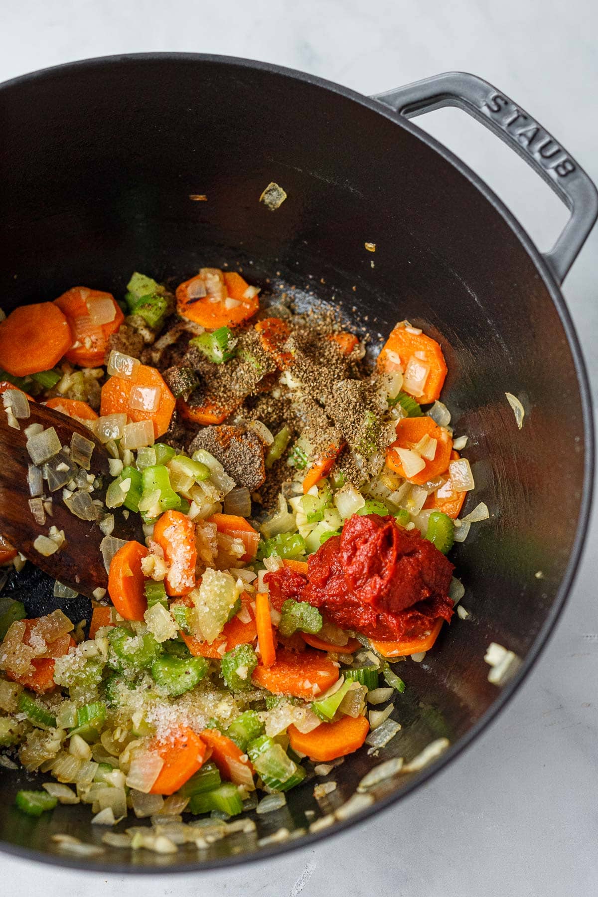 dutch oven with sautéed veggies with spices and tomato paste.