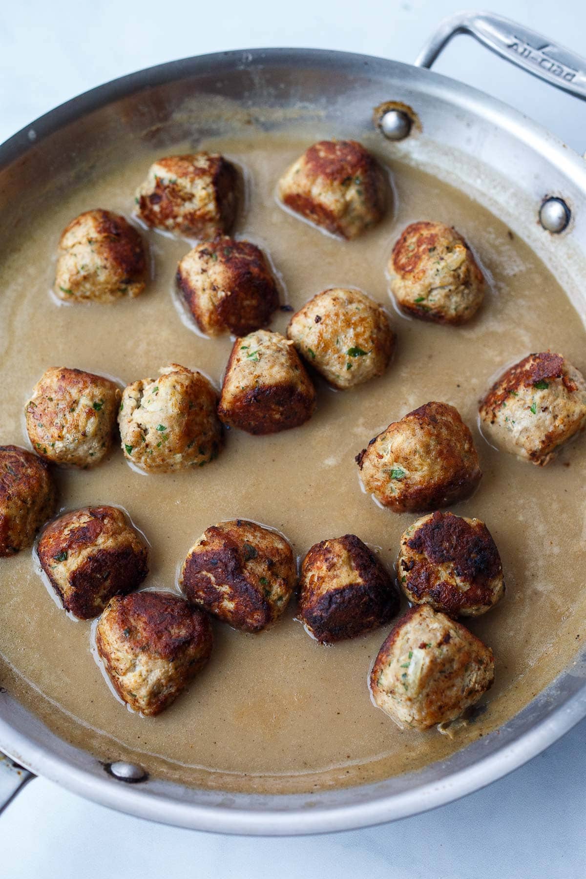 browned Swedish meatballs added to pan with brown gravy.