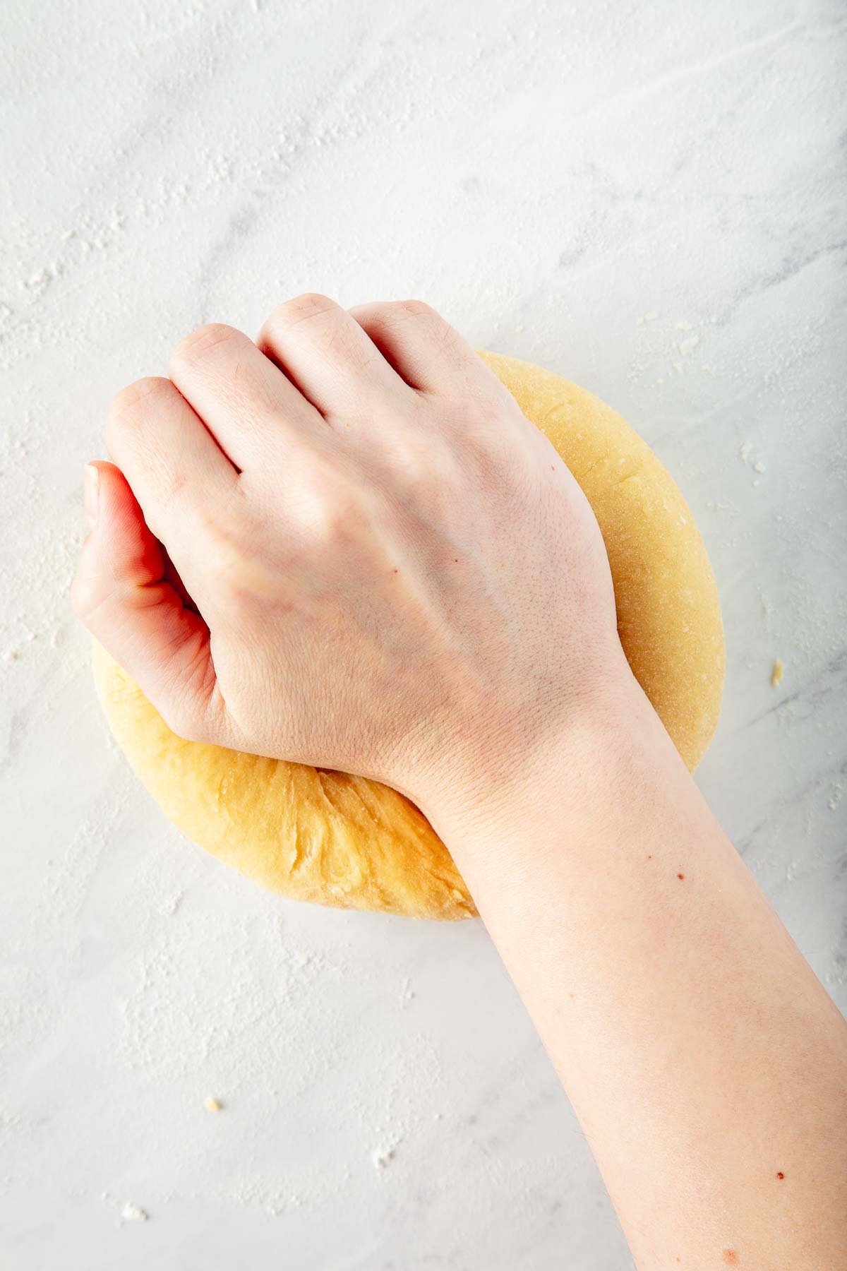hand kneading homemade pasta dough.