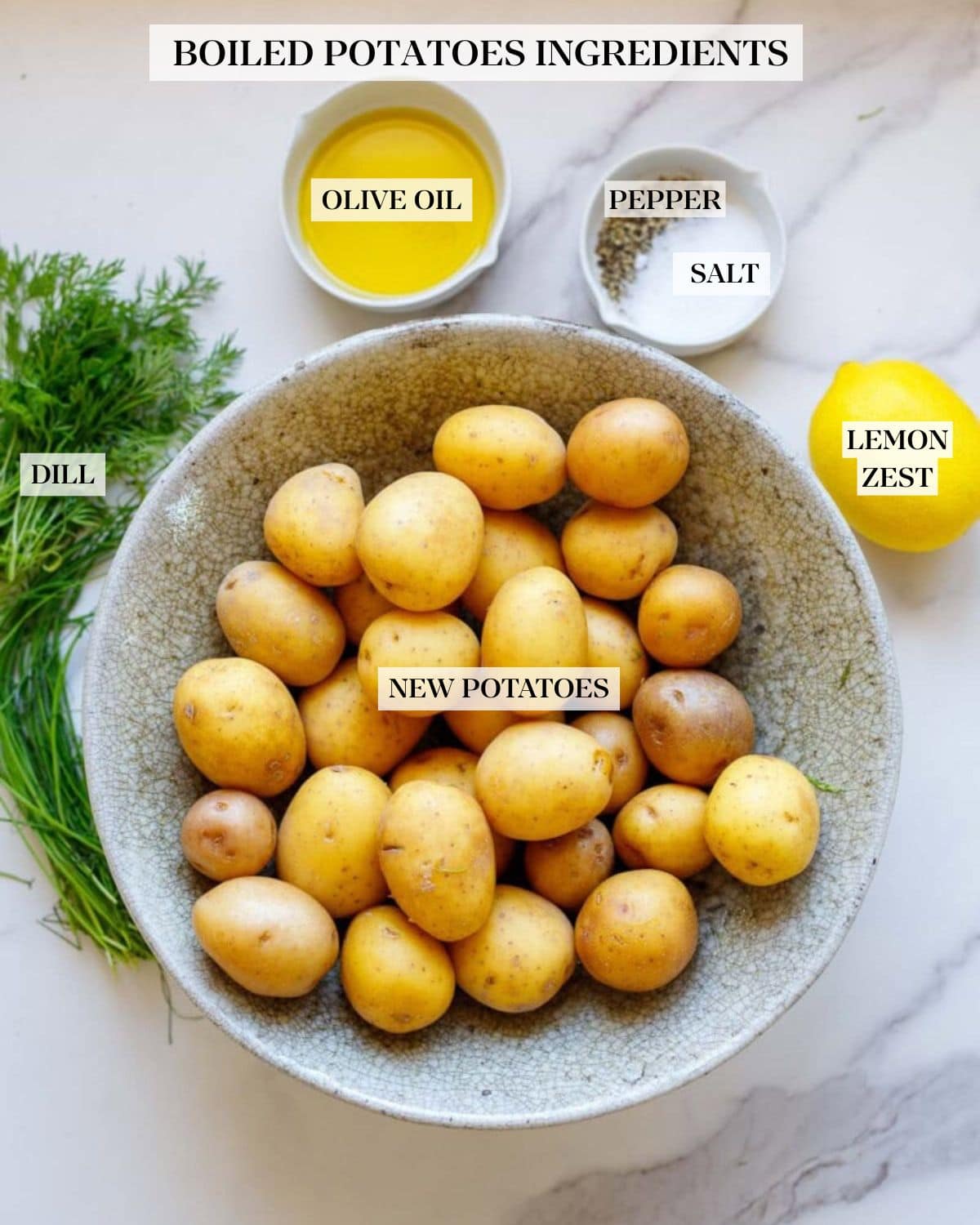bowl of new potatoes next to lemon, salt and pepper, olive oil, and fresh dill.