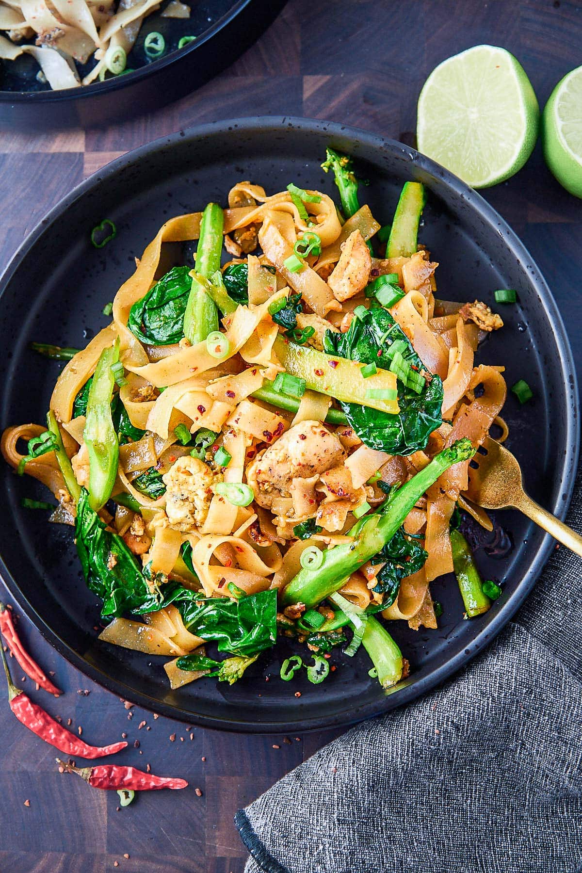 Pad See Ew is a delicious Thai stir-fried noodle dish using wide rice noodles, Chinese broccoli, eggs, your choice of protein ( chicken, tofu, shrimp) and a flavorful sweet soy stir-fry sauce.
