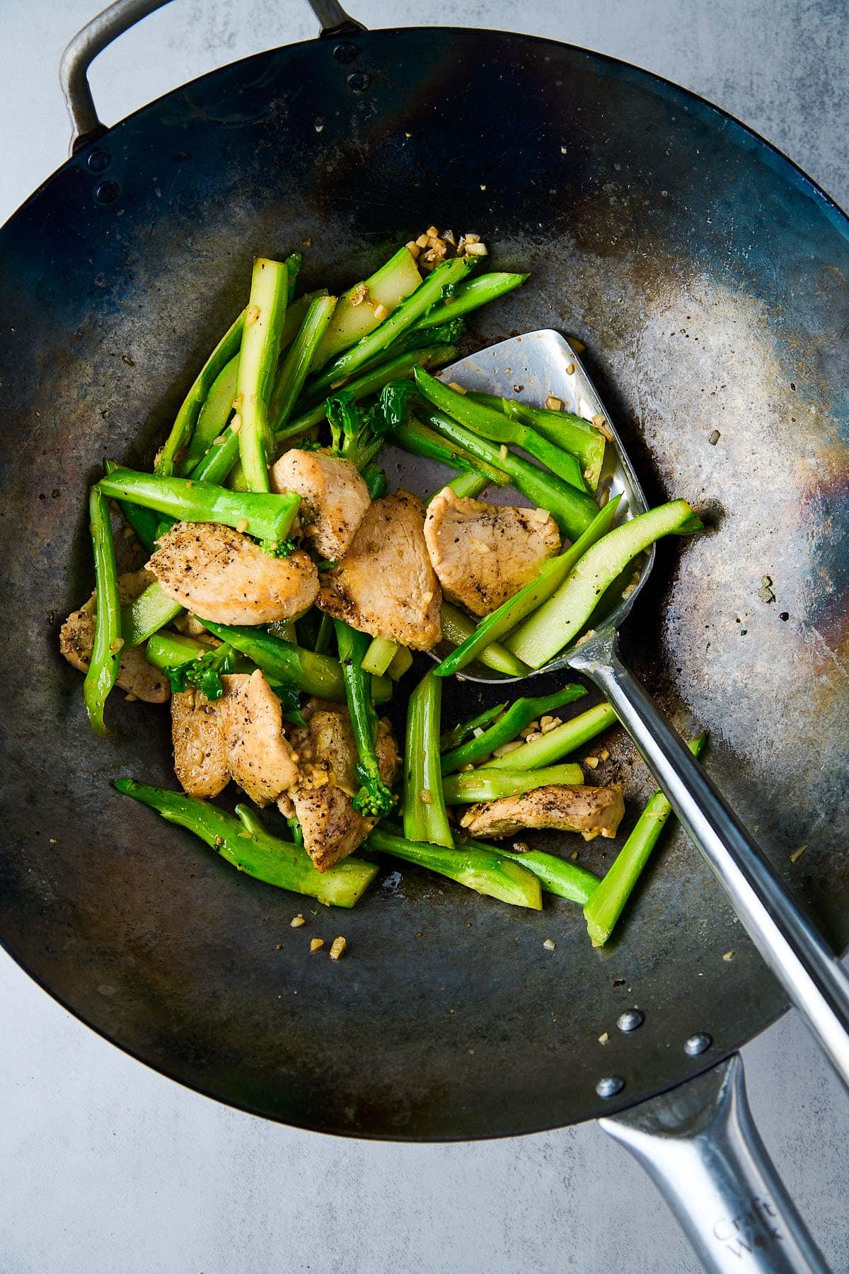 wok with Chinese broccoli and seared chicken. 