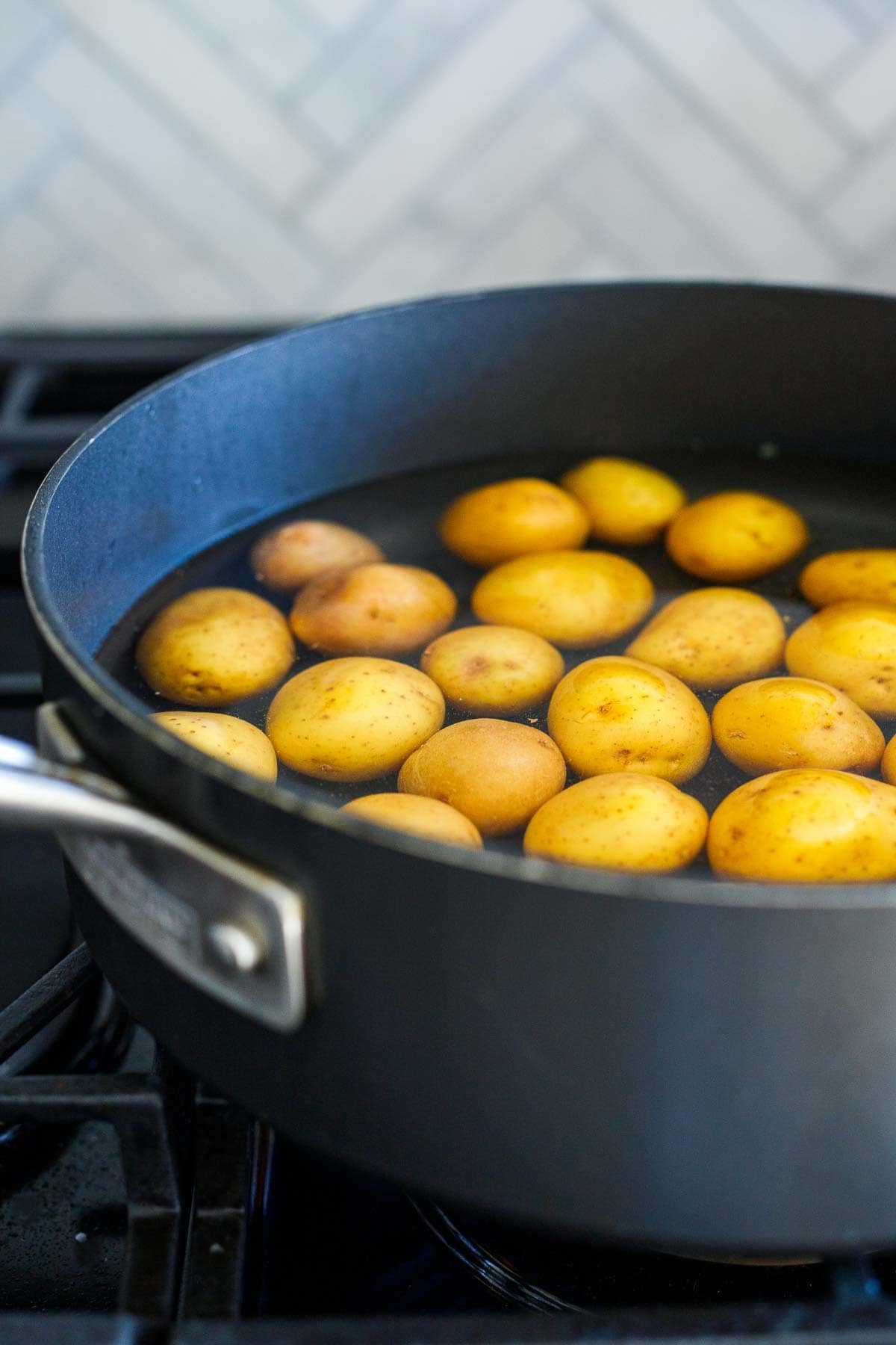 pot of water with baby potatoes.
