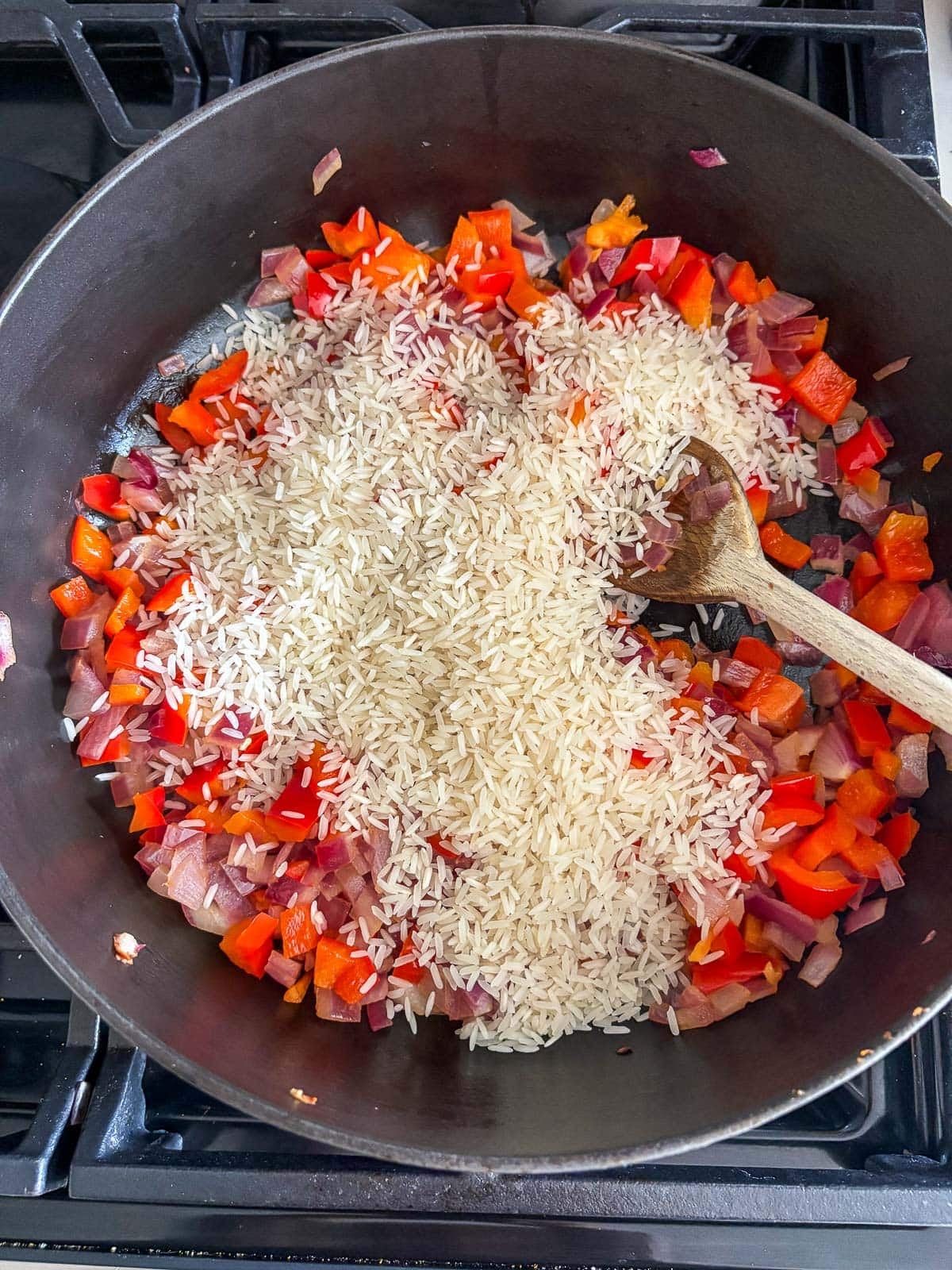 dutch oven with sautéed pepper and onion with white rice.