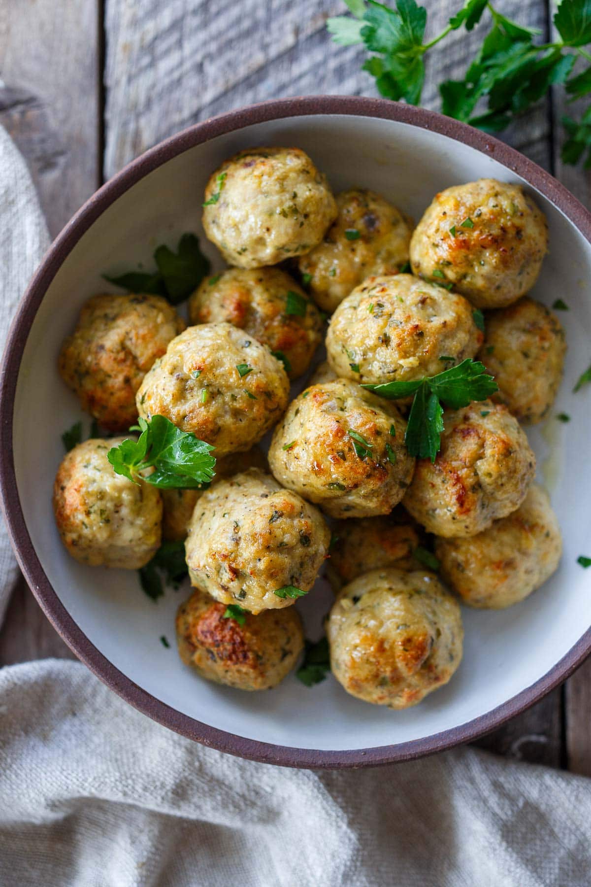 bowl of Greek chicken meatballs topped with fresh parsley.