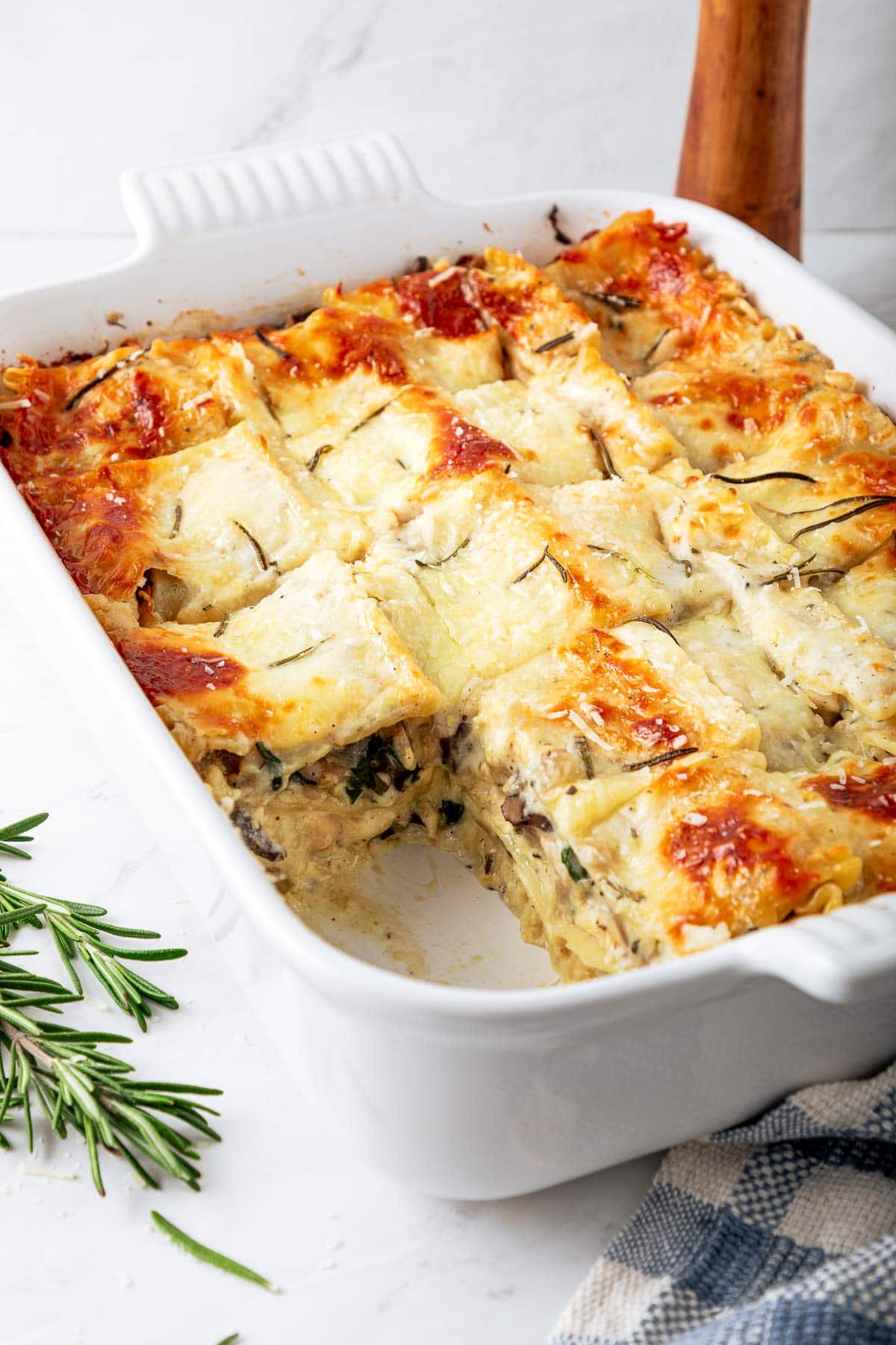 A delicious, cozy recipe for Rosemary Chicken Lasagna with mushrooms and spinach in a creamy Béchamel Sauce. A hearty meal perfect for special gatherings or Sunday supper. Vegetarian-adaptable. Video!