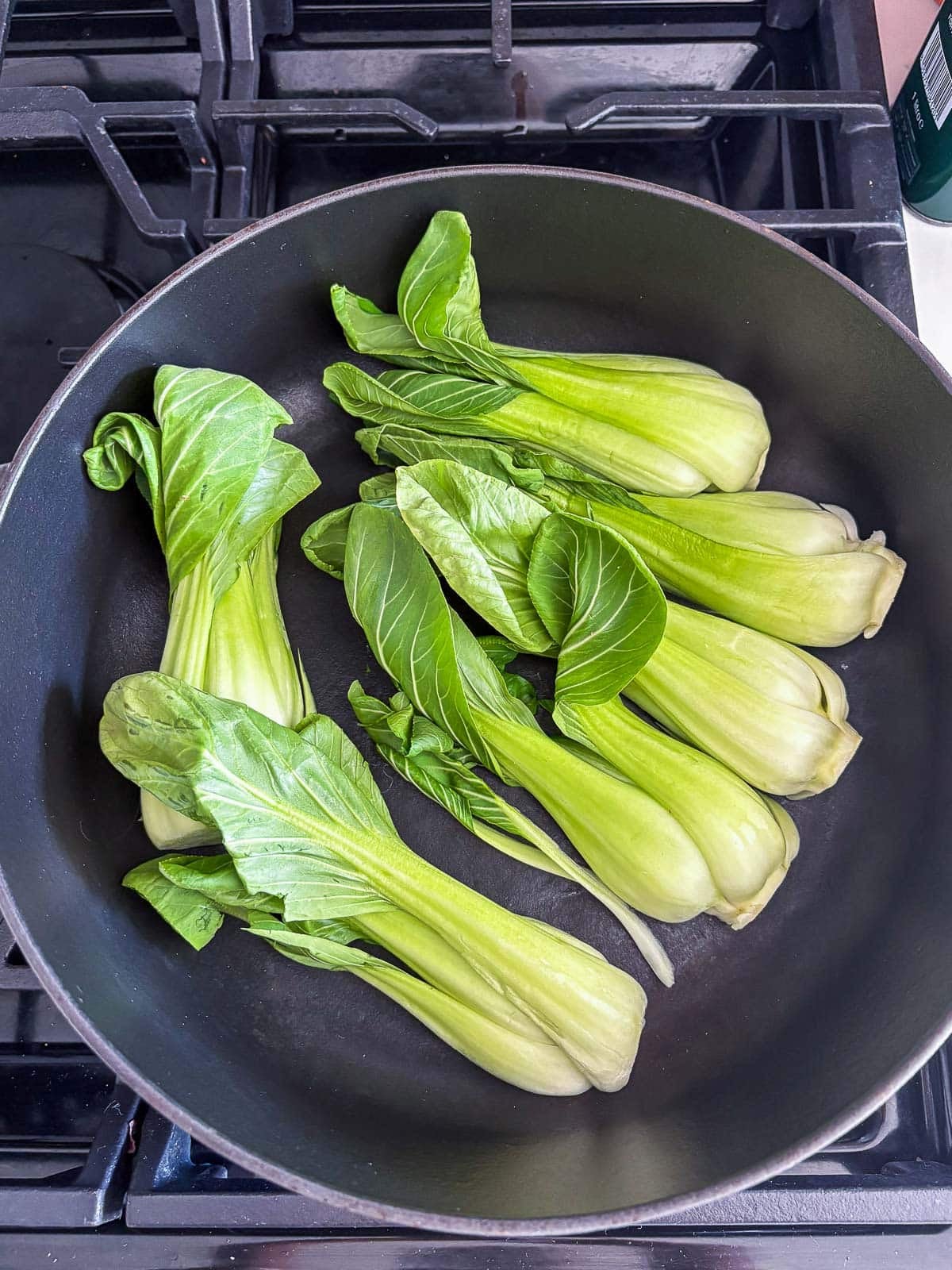 baby bok choy cut-side down in braiser to sear.