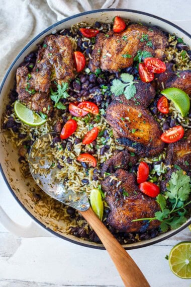 This one-pan Mexican chicken and rice with black beans features seared, spice-rubbed chicken thighs nestled into savory sofrito rice. A hearty, flavorful dinner ready in under an hour.