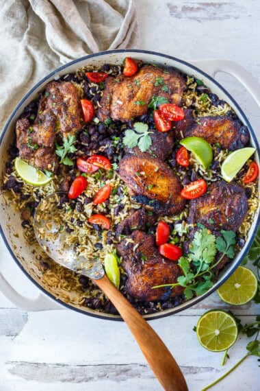 This one-pan Mexican chicken and rice with black beans features seared, spice-rubbed chicken thighs nestled into savory sofrito rice. A hearty, flavorful dinner ready in under an hour.